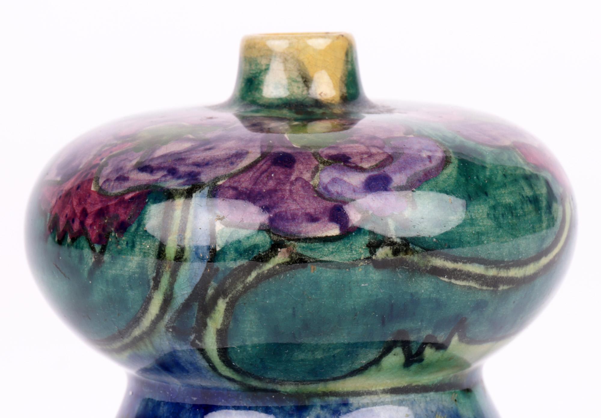 An exceptional and rare quality Dutch hand-painted floral design art pottery vase made at the Plateelbakkerij Zuid-Holland (PZH) Gouda factory and dating from the early 20th century. The finely made miniature vase is made in an inverted thistle