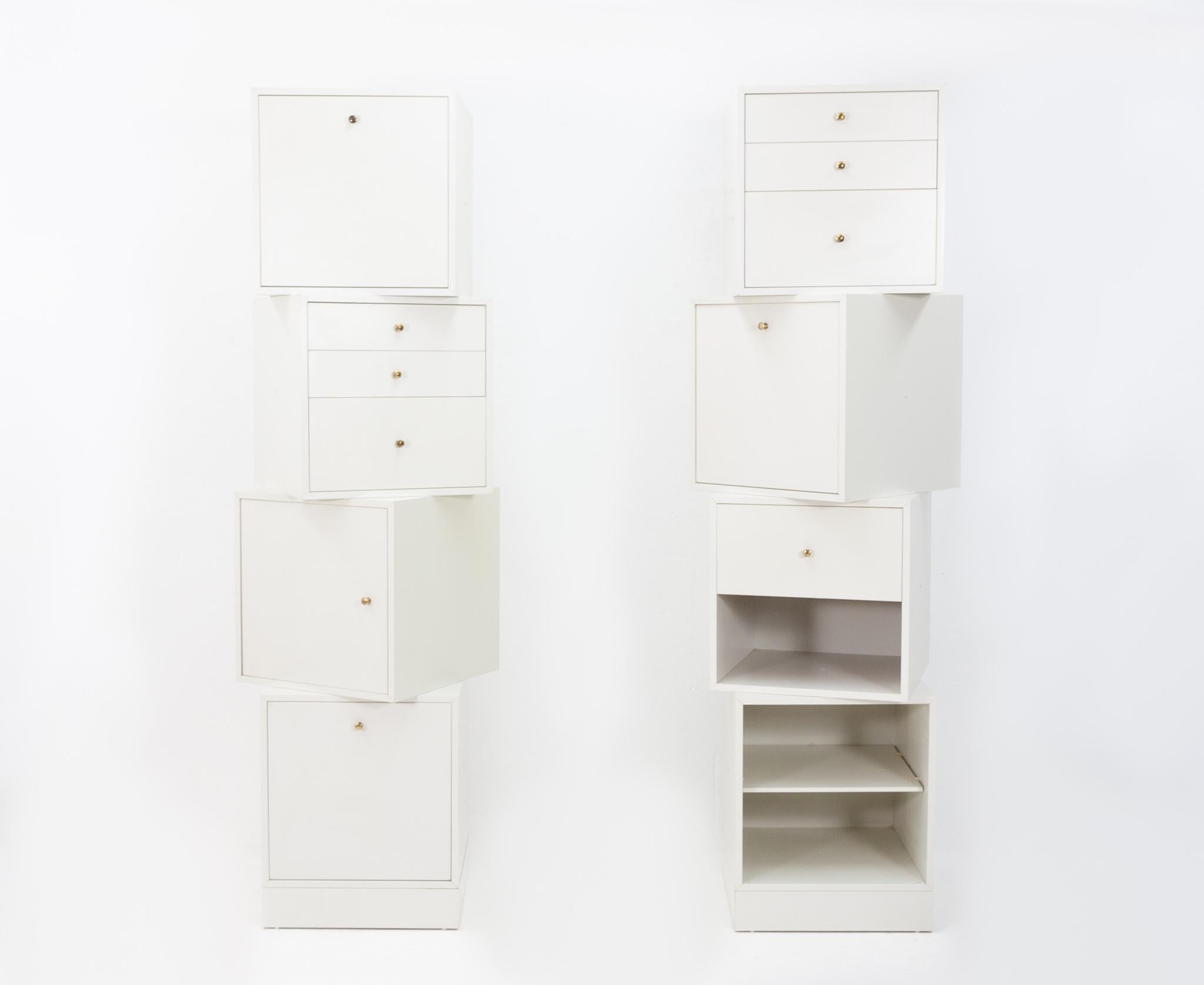 The Q-bus storage system. Design Cees Braakman for Pastoe, 1965. Consisting off eight small Q-bus on top off each other, connected by a plug. They have all the same sizes. 37.5cm x 37.5cm x 37.5cm Laminated wood with brass details. Off white