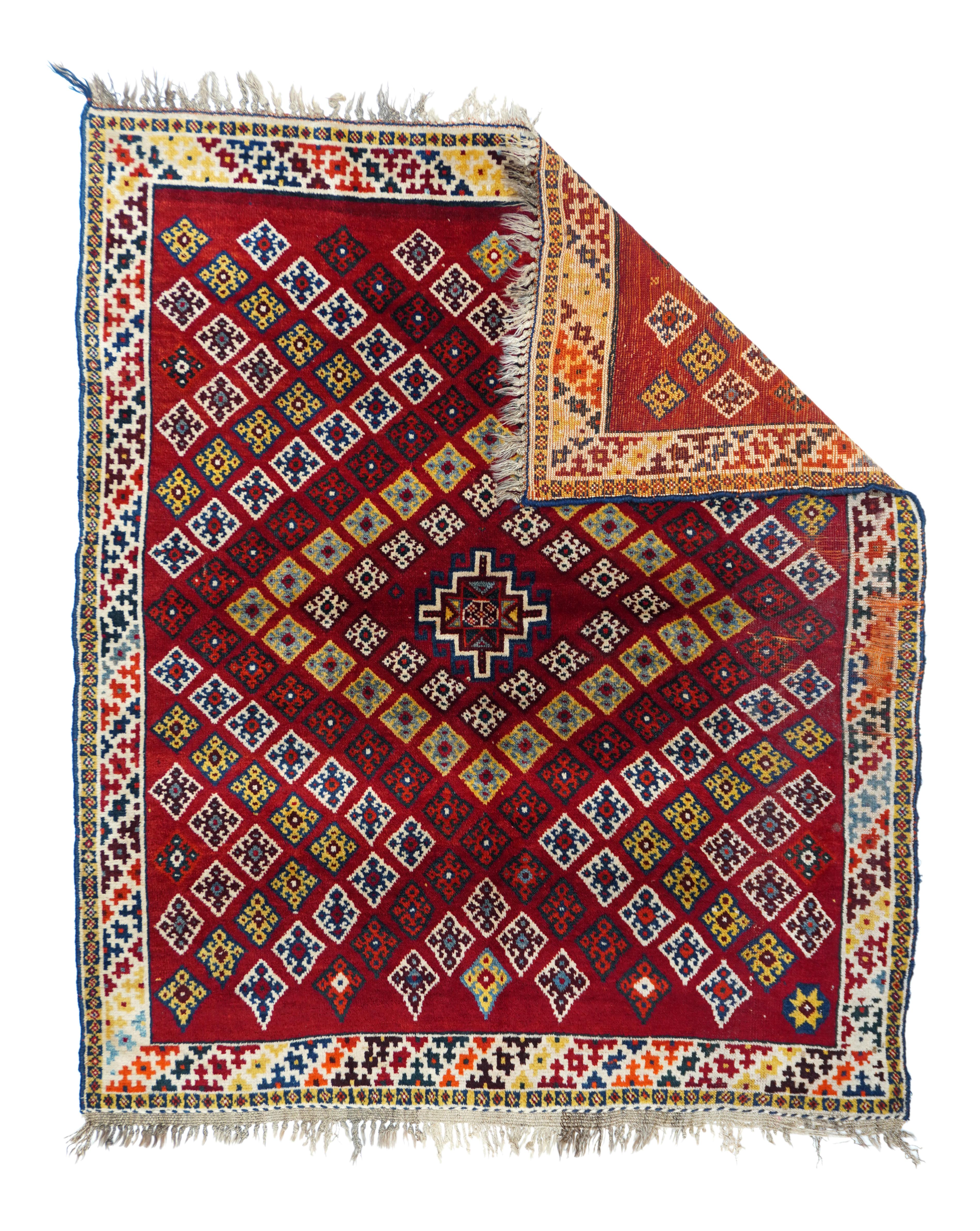 A pile nomadic scatter woven exactly in a kilim design with a red fields patterned with small diamonds forming large diamond-shaped colour-defined over patterns. Yellow, ivory, navy , light blue and orange-red accents. Ivory border with colour