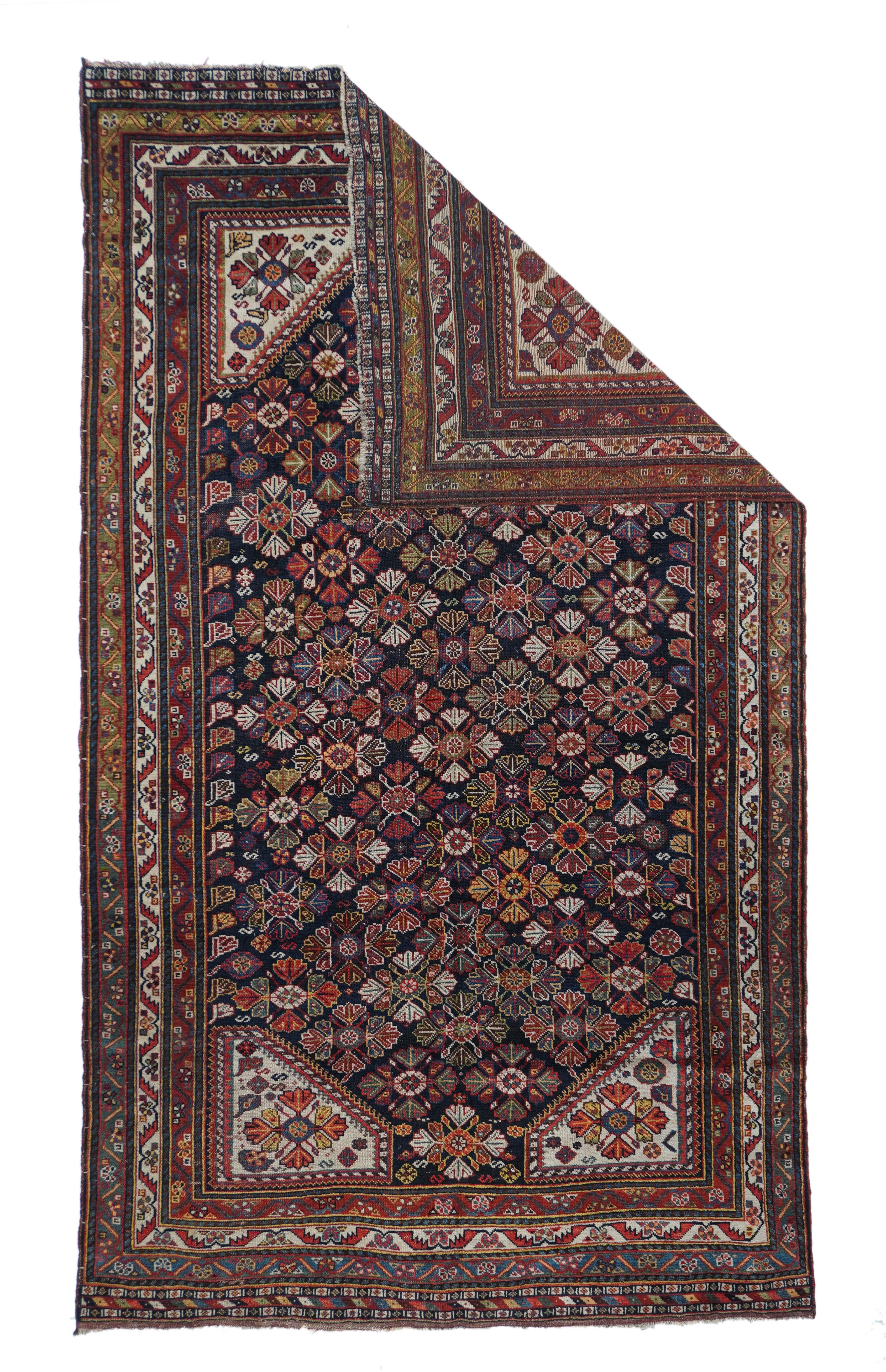 This modern western Turkish town carpet features a five column design of tilted palmettes, symmetrized ragged palmettes and little florets, all accenting a lozenge lattice on a light green field. Green border with palmettes, red slit meander, and
