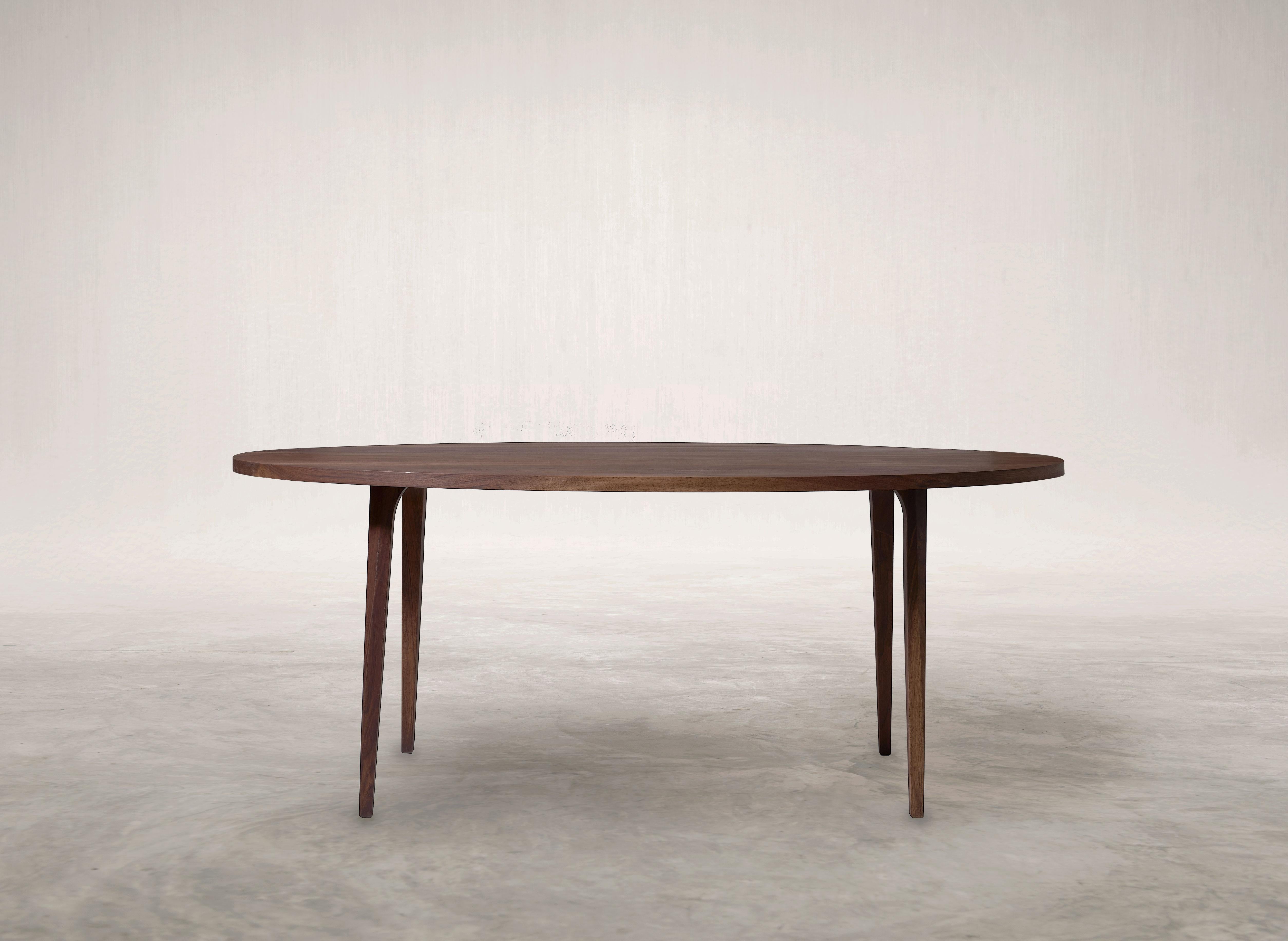 Qaws Dining Table by Selma Lazrak
Dimensions: D 223 x W 104 x H 74 cm 
Materials: Solid American walnut.

The term Qaws is used to describe arches of various shapes and sizes, commonly found in buildings like palaces, and historic structures