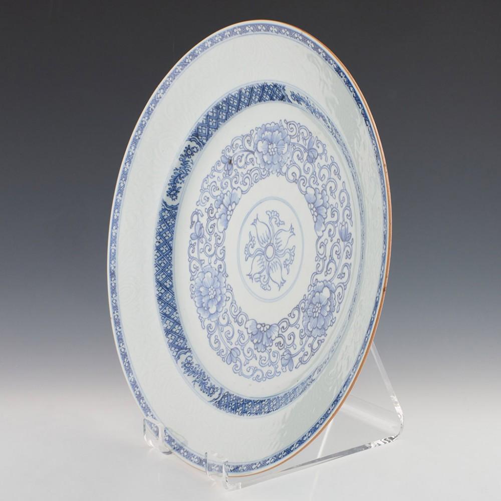 Heading :  Qianlong period blue and white charger
Date : 1735-1795
Period : Qianlong
Origin : China
Colour : Blue and white
Pattern : Painted with concentric narrow and broad bands of scrolling peonies enclosed within an outer band of incised