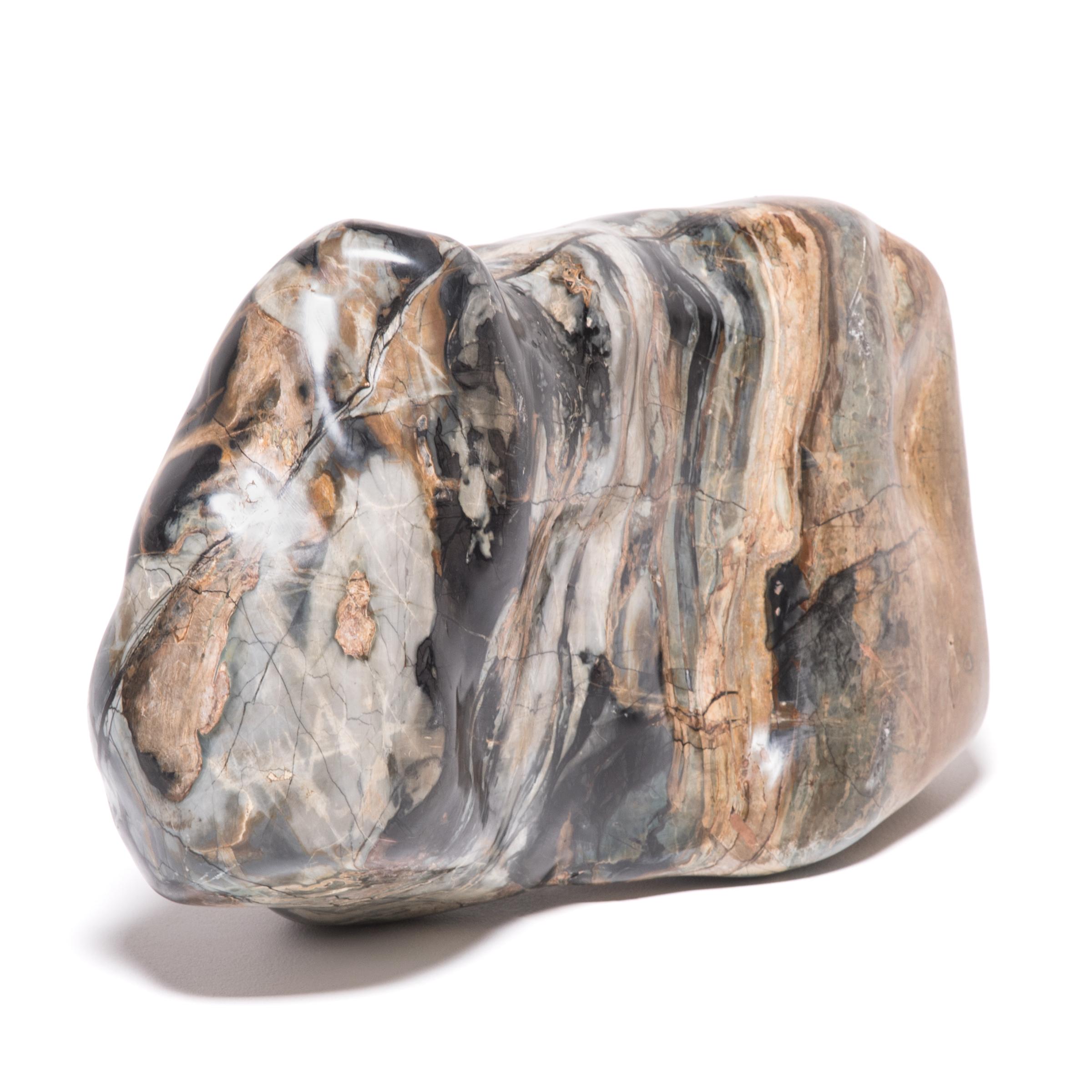 A well-chosen stone is a focal point of both a traditional Chinese garden and a scholar's studio - evoking the complexities of nature and inspiring creative thought. The form of this mesmerizing stone calls to our minds the auspicious qilin, a