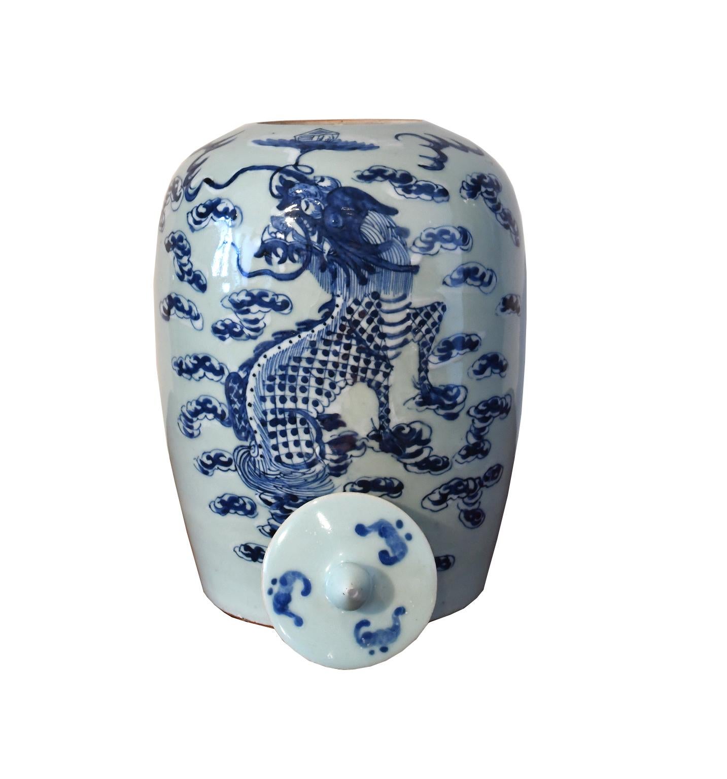 A very beautiful Chinese porcelain baluster-shaped jar with lid and knob, painted in underglaze blue crackle with hand-painted cobalt blue and white decorations depicting a two-horned, five-clawed dragon amid clouds, who is carrying into the heavens