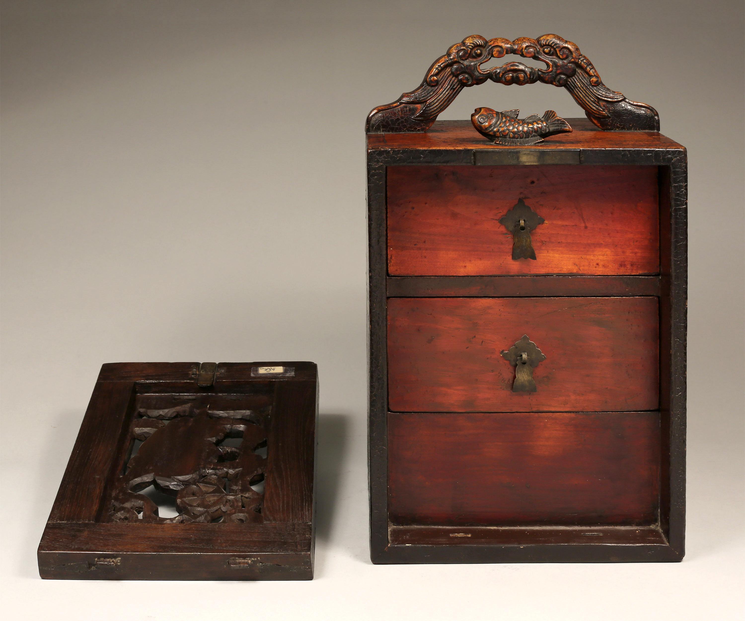 High official's box for his seals (chops) from China.
Qing Dynasty (18th/19th century)
It is decorated with carved dragon handle, a fish and a Fu dog surrounded floral motifs. 
Measures: W: 10 in x H: 19 in x D: 8.5 in.
    