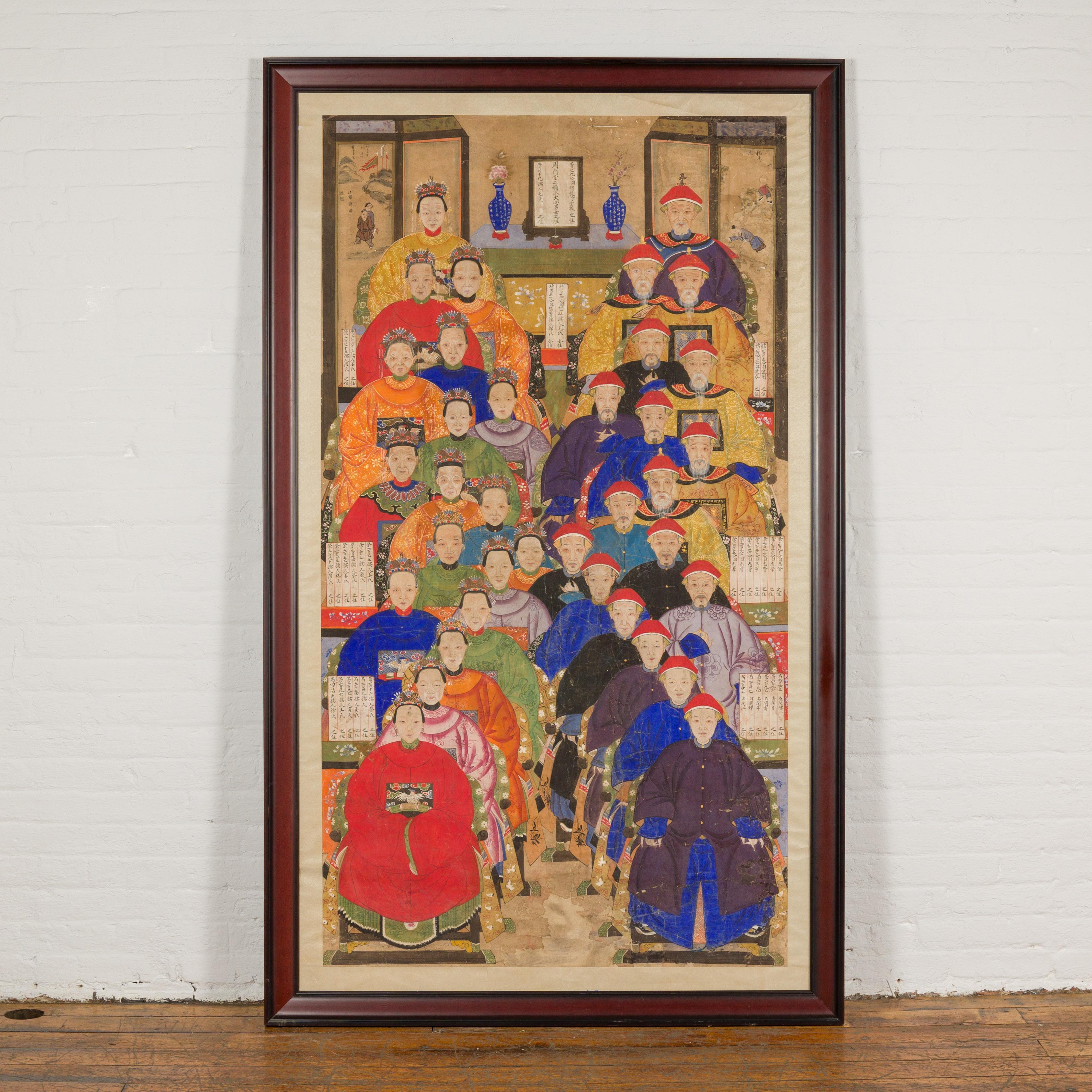 A Chinese Qing Dynasty period painting from the 19th century of an ancestral group portrait in custom frame. Immerse yourself in the rich tapestry of Chinese history with this Qing Dynasty period painting, an ancestral group portrait from the 19th