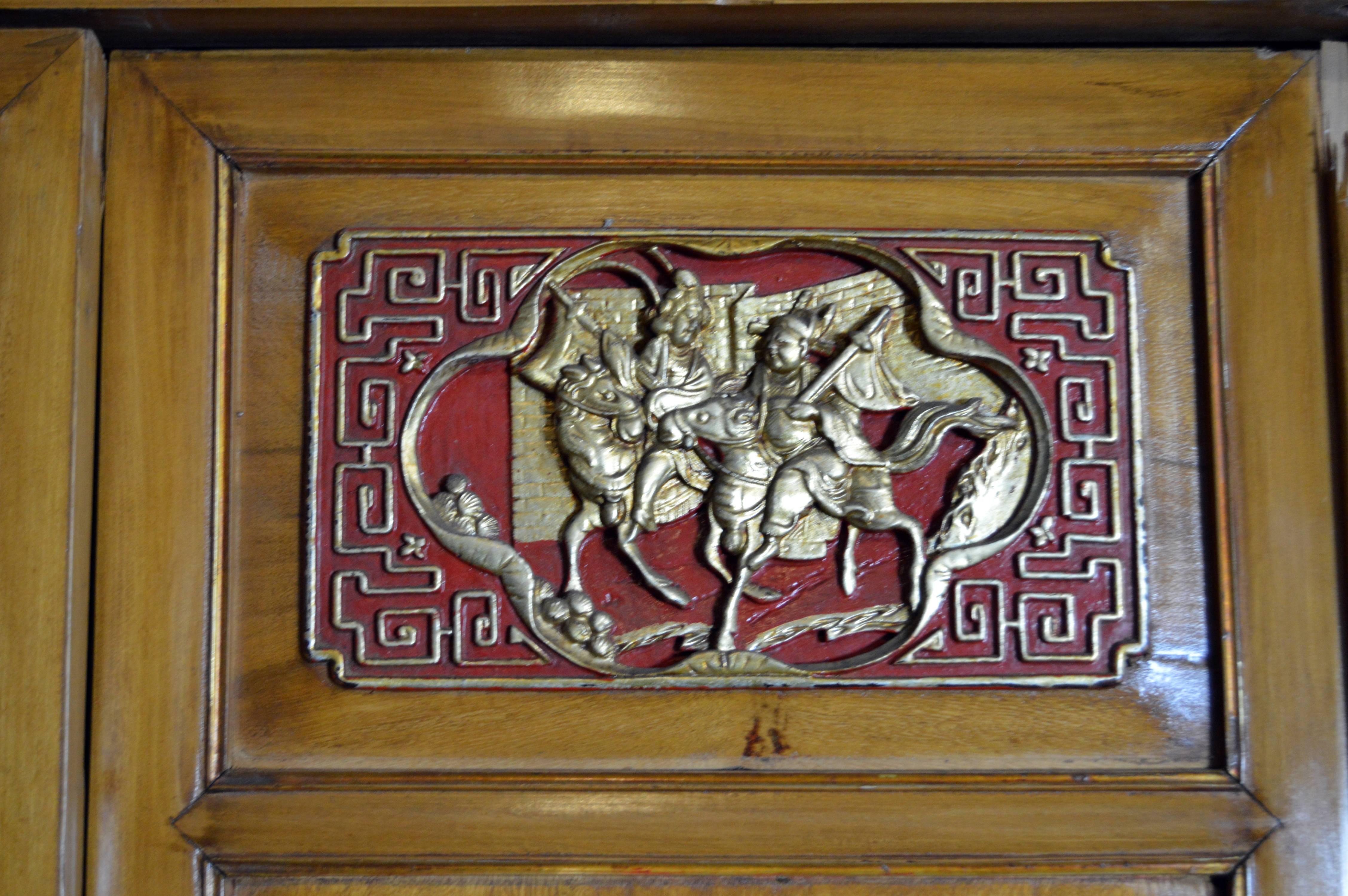 Qing Dynasty 19th Century Chinese Wooden Armoire with Hand-Carved Gilt Panels In Good Condition In Yonkers, NY