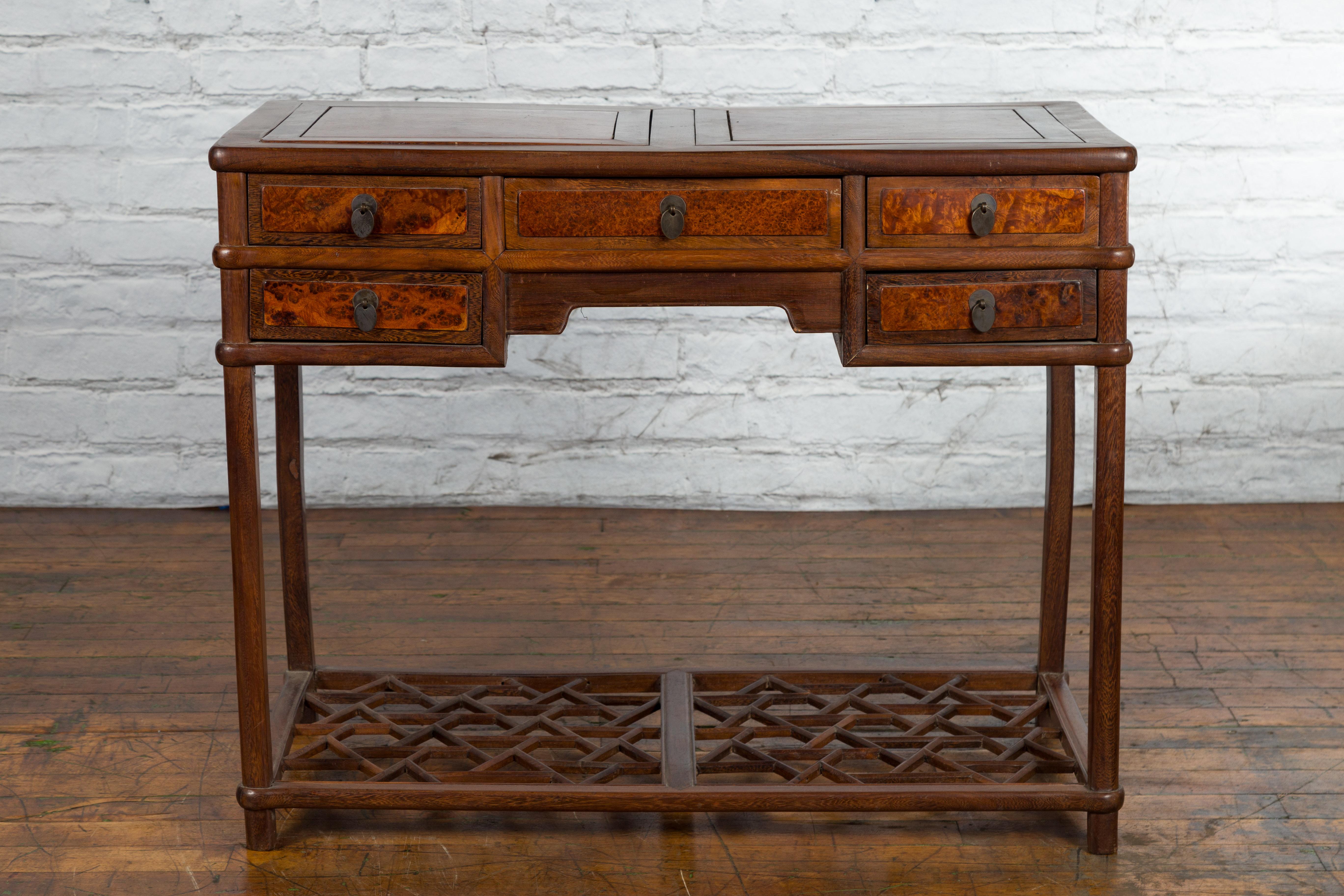 A Chinese Qing Dynasty period wooden desk from the 19th century, with burlwood inset top, five drawers and cracked ice base. Created in China during the Qing Dynasty, this wooden desk features a burlwood two-panel inset top sitting above five burl
