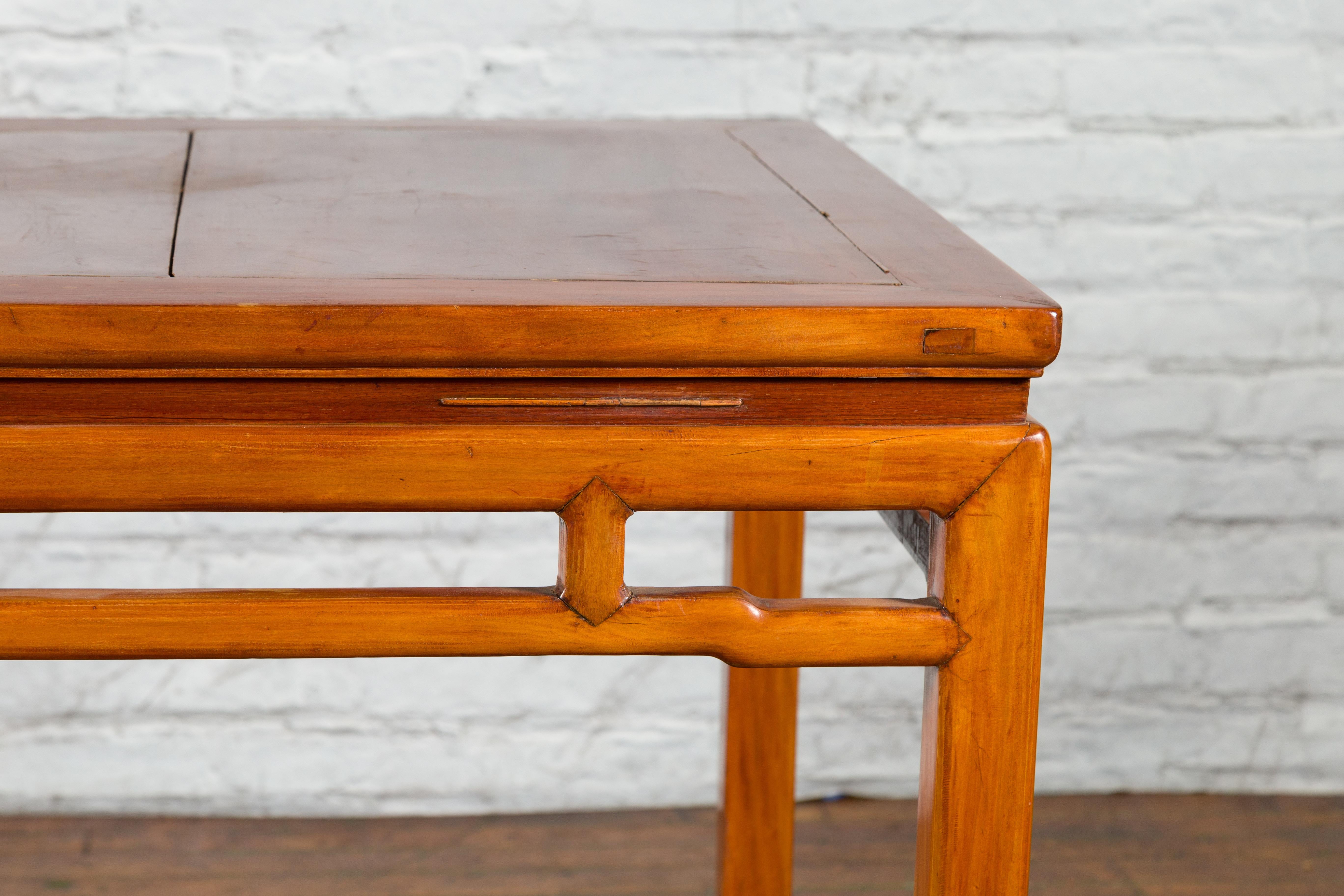 Fruitwood Qing Dynasty 19th Century Table with Humpback Stretchers and Horse Hoof Legs For Sale