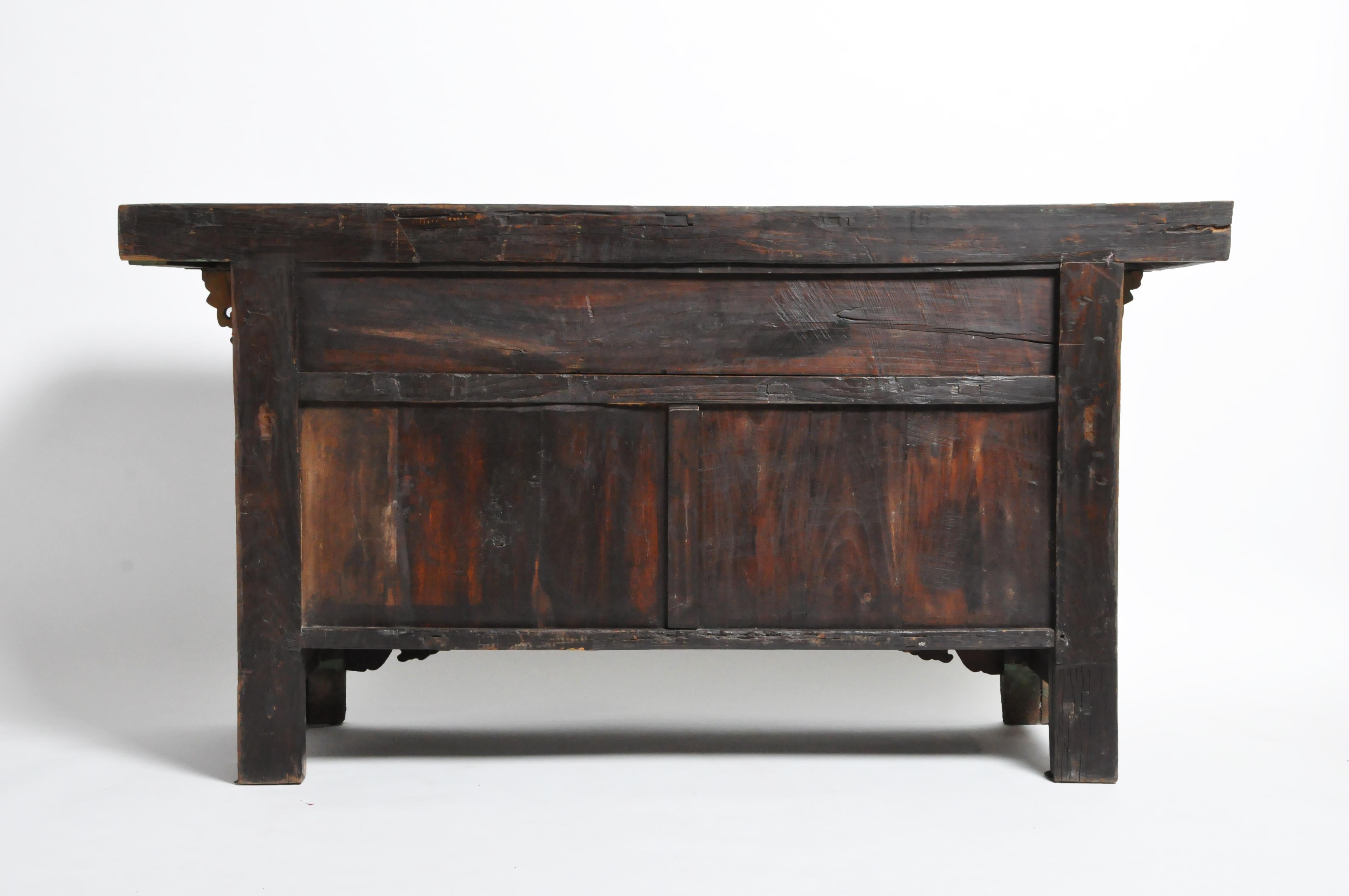 This gorgeous altar coffer is from China and was made from elmwood and lacquer, circa 1880. The piece features its beautifully aged original patina with 4 drawers and a pair of doors for storage. The coffer dates to the late-Qing Dynasty period.