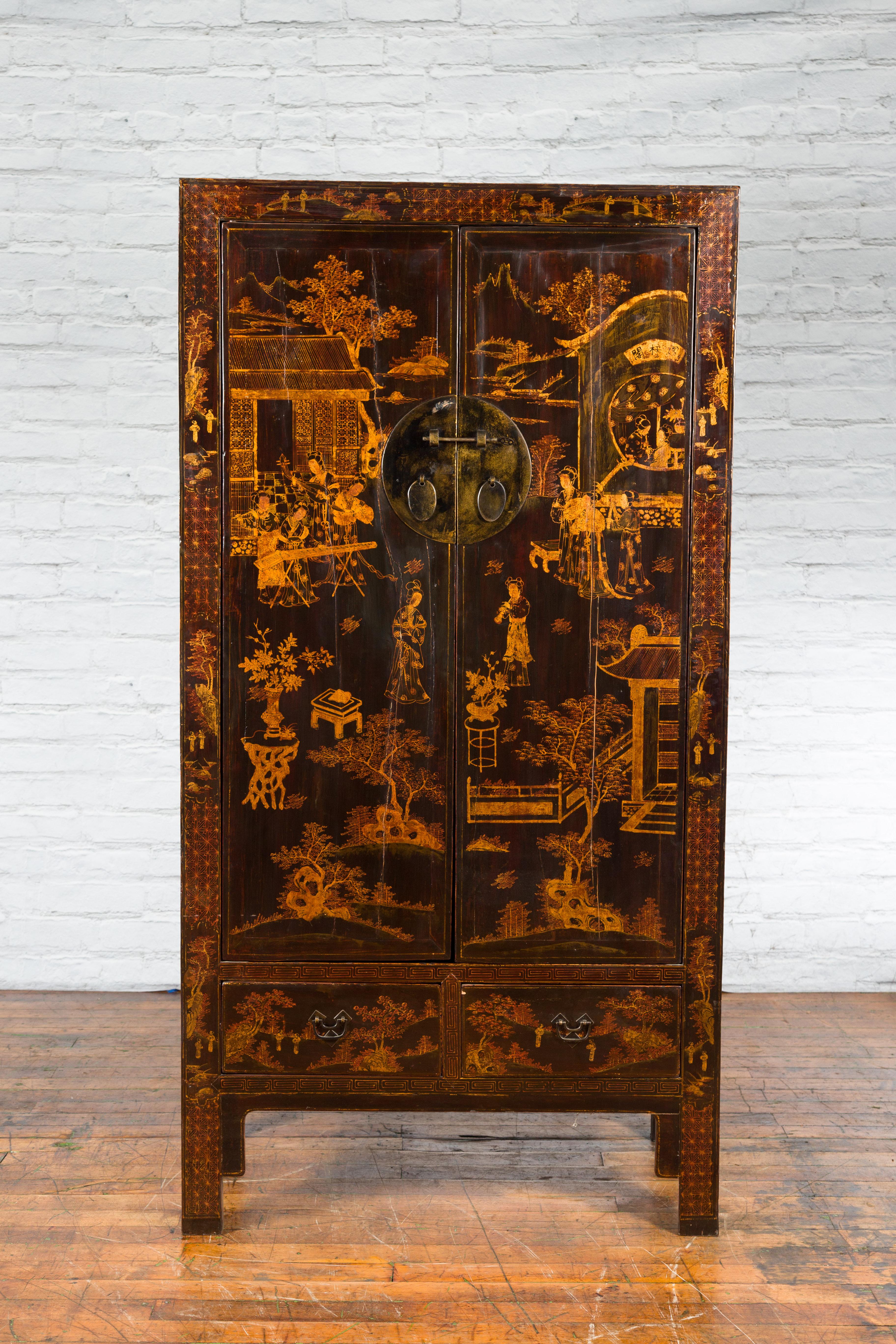 A Chinese Qing Dynasty period dark brown lacquered armoire from the 19th century with gilt hand-painted décor, bronze medallion hardware, inner shelves and hidden drawers. Created in China during the Qing Dynasty in the 19th century, this tall