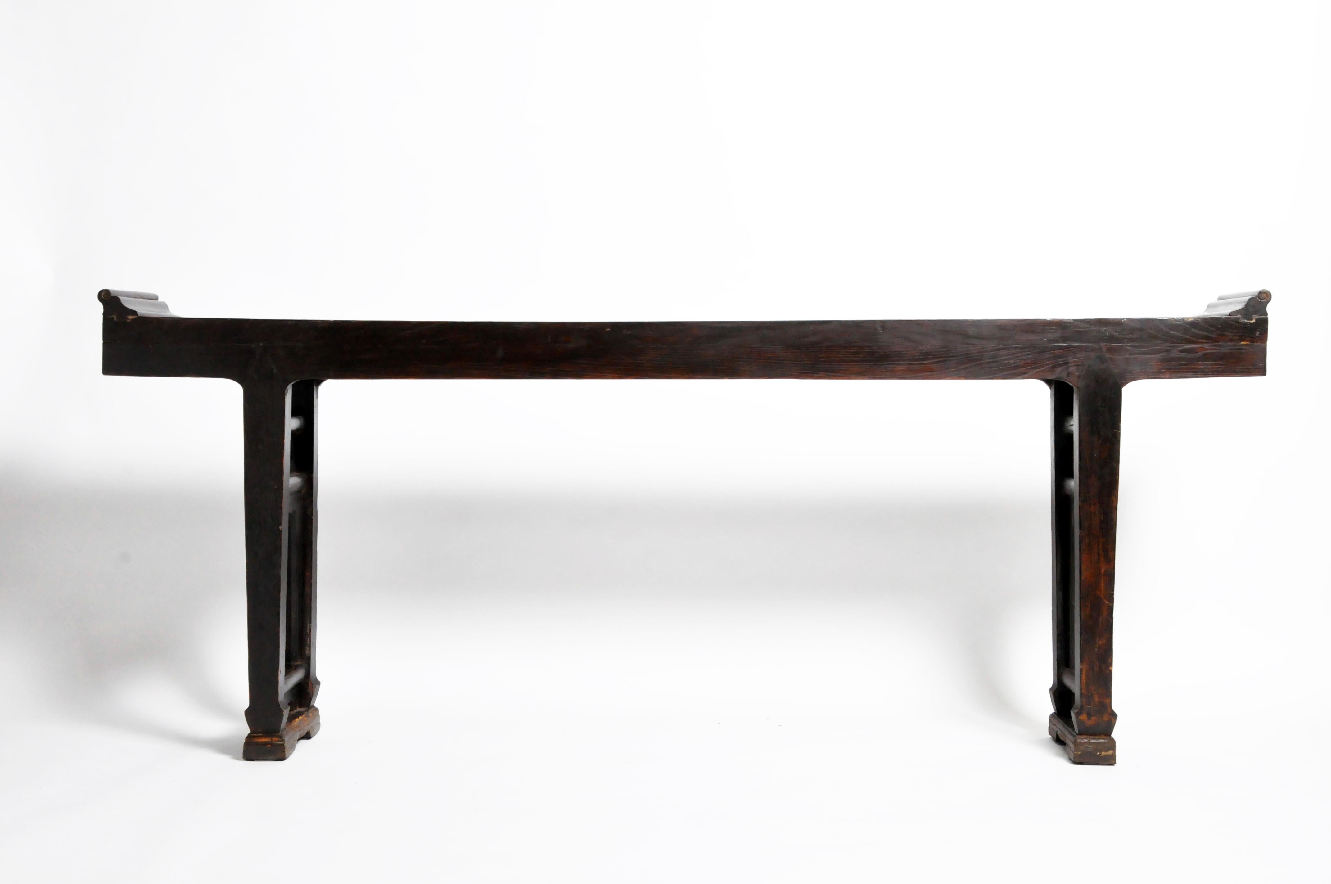This handsome altar table is from Shanxi, China and was made from elmwood, circa 17th century. The piece features double stretchers for support, a beautifully aged patina, and dates to the Qing Dynasty. Wear consistent with age and use. Great as a
