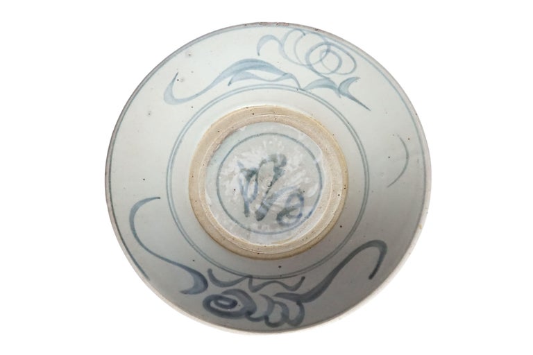 This Chinese ceramic plate is dominated by a blue-grey glaze and features wonderful hand painted blue strokes. Once used as an every day plate it is now a great example of Chinese ceramic and would make for a wonderful serving plate, table