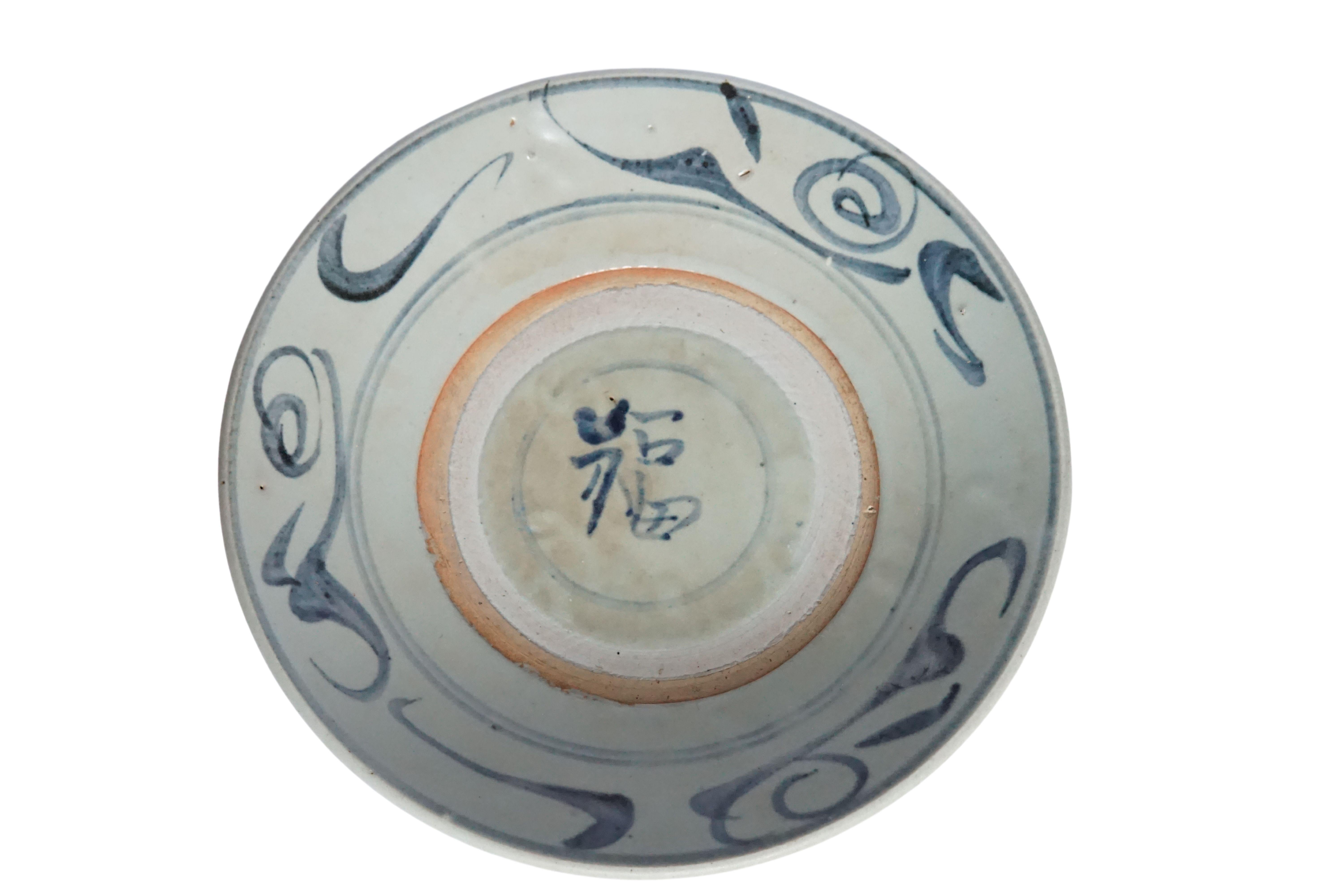From the Qing Dynasty, this Chinese ceramic plate is dominated by a blue-grey glaze and features wonderful hand painted blue strokes. Once used as an every day plate it is now a great example of Chinese ceramic and would make for a wonderful serving