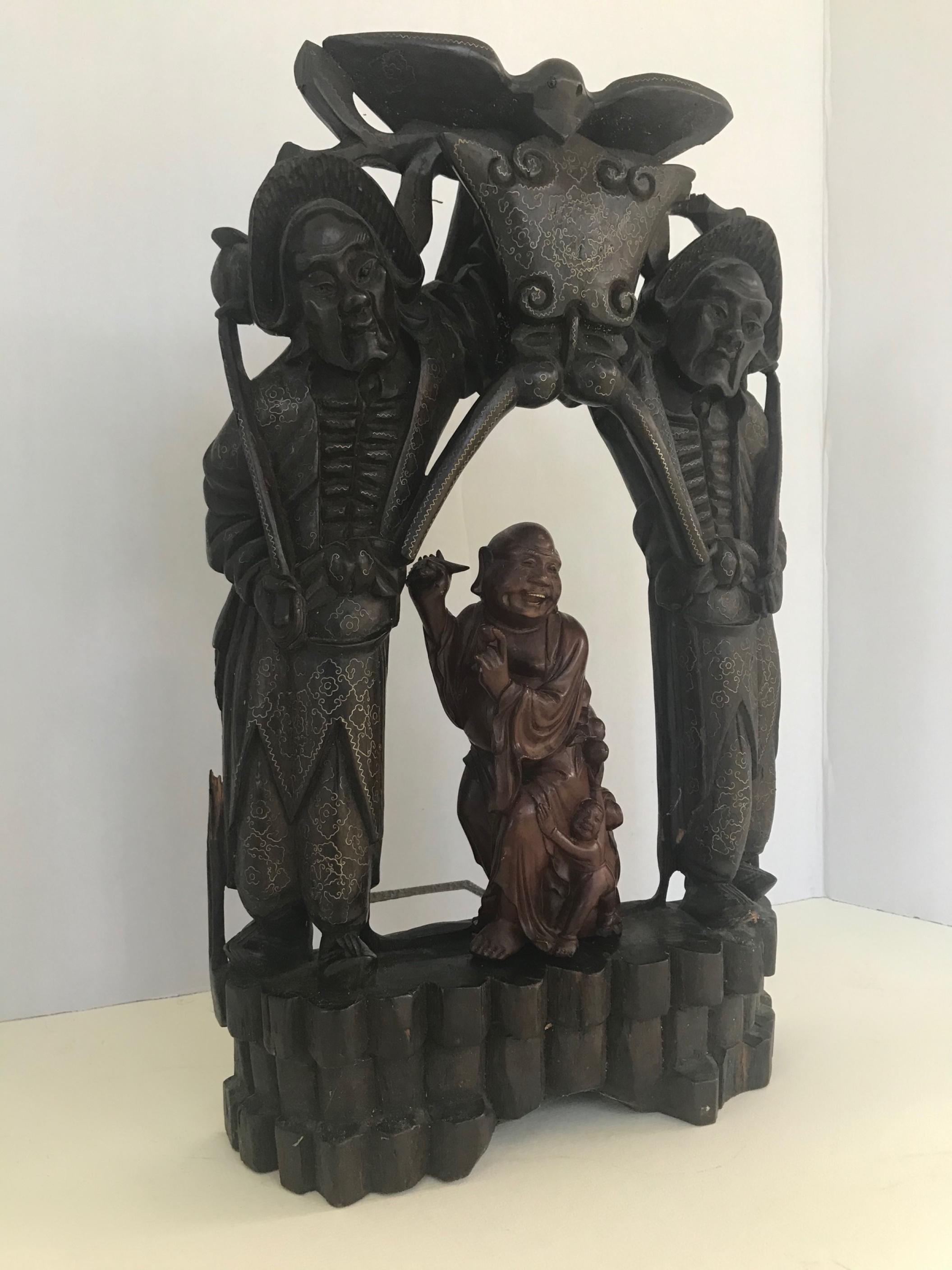 Qing Dynasty Chinese Buddhist wood carved portable shrine.

Imperial Qing Dynasty Chinese intricately openwork carved altar shrine. It is hand
carved in hardwood and depicts two strong sword carrying guardians with glass eyes standing watch in