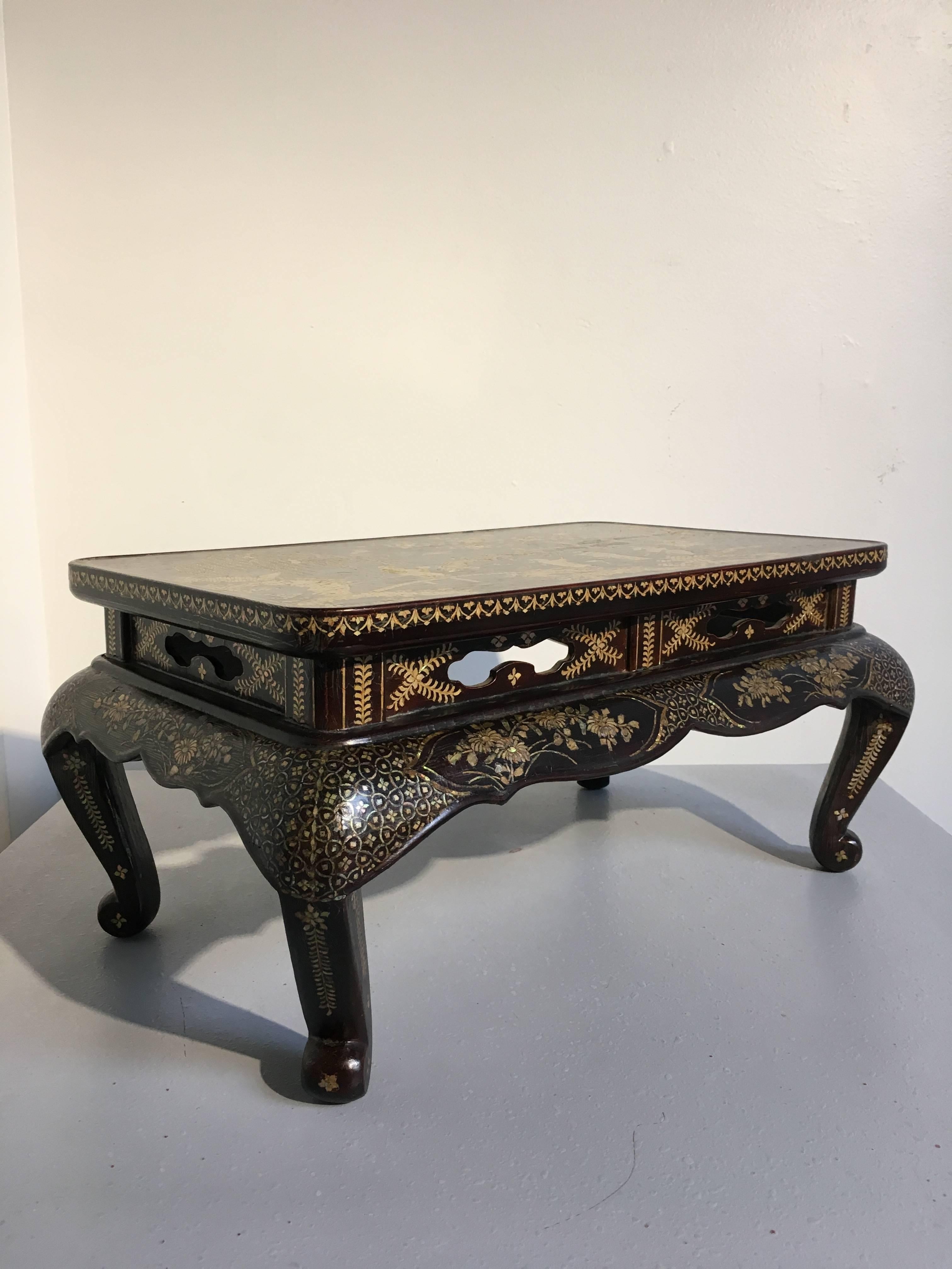 A stunning mid-Qing dynasty Chinese lacquer and mother-of-pearl inlaid small table, originally used as a scholar's display stand or incense table.
The top of the table inlaid with mother-of-pearl to depict a landscape scene of scholars in an ornate