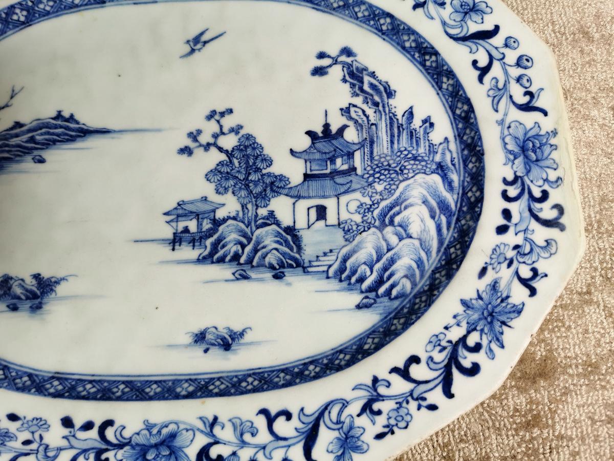 Chinese porcelain tray /shallow bowl with hand-painted decoration in cobalt blue under glass depicting a delightful lake landscape with a graceful bird in flight, the border presents rich and elaborate floral motifs. There are no markings to the