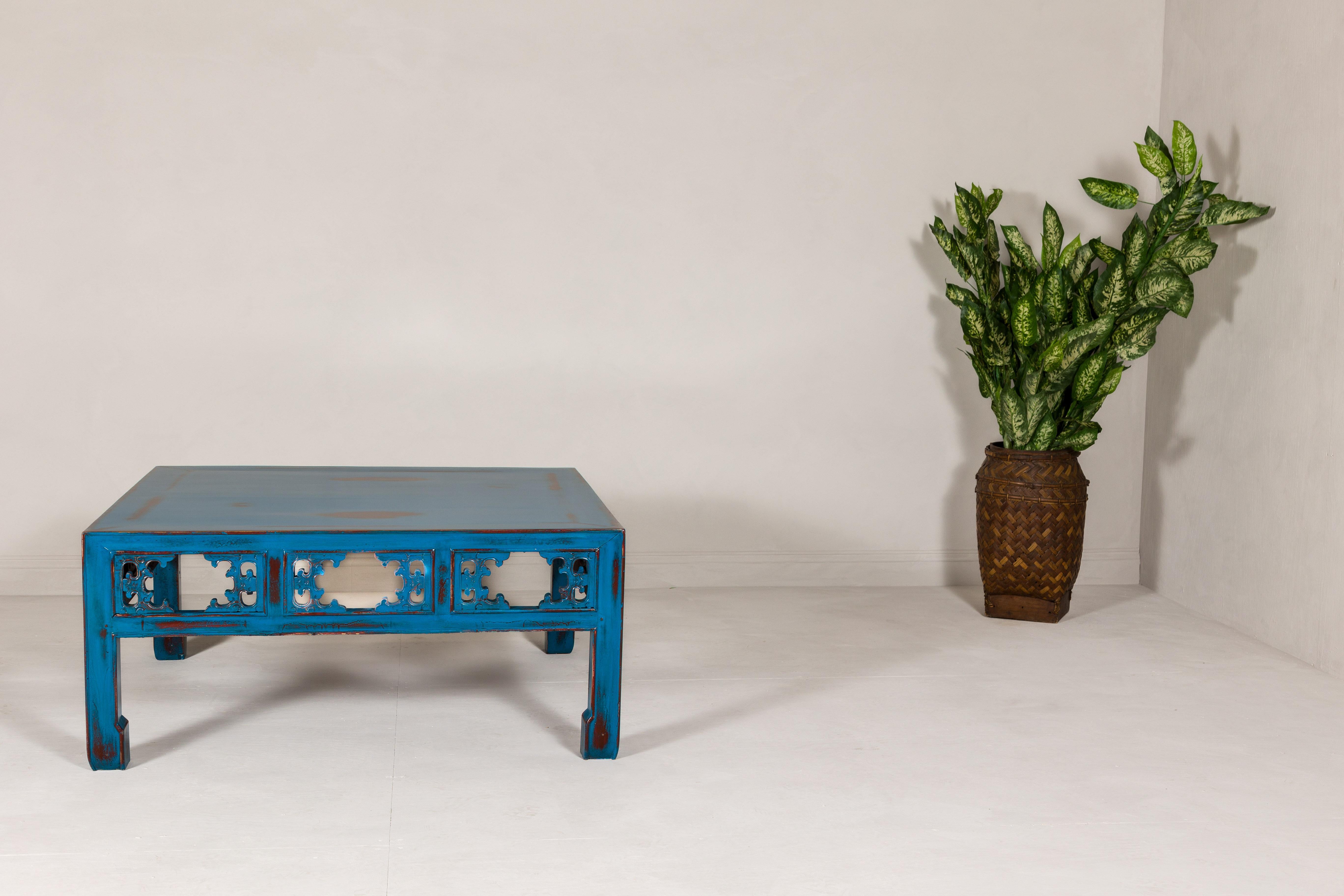 A one of a kind antique Chinese Qing Dynasty period coffee table with carved apron and horse hoof legs, newly custom lacquered in blue distressed finish. Step into a world of timeless elegance with this Chinese Qing Dynasty coffee table, a piece