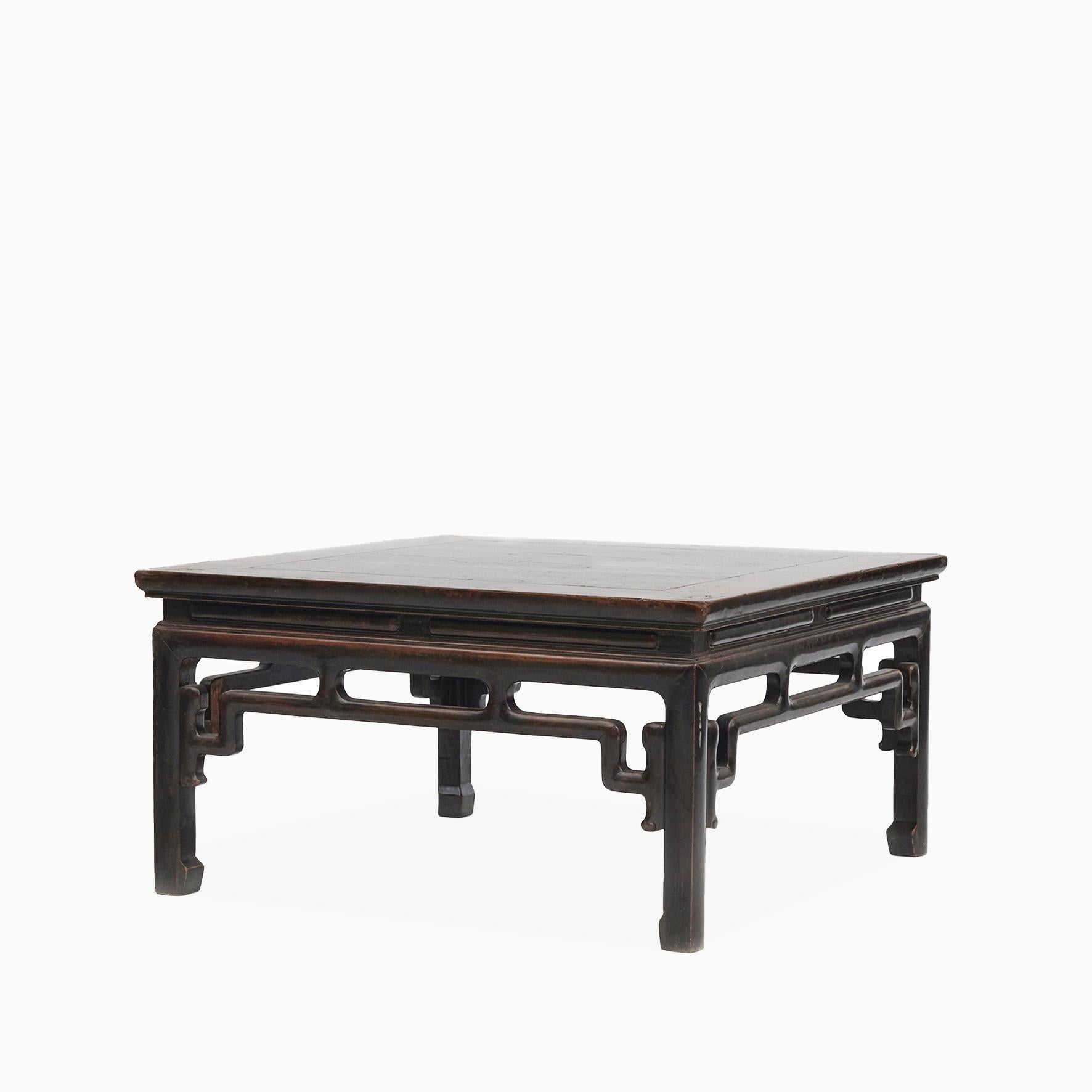 A Chinese Qing Dynasty period walnut wood coffee table from the 19th century
Square top with waisted apron atop a black lacquered frame and horse hoof legs.

The table has a natural age-related patina enhanced with a clear lacquer finish.

China