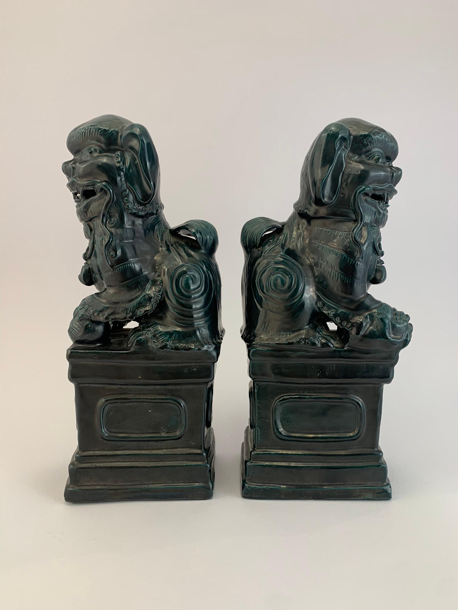 Beautiful pair of ornaments in the shape of foo dogs, protectors of the home and the world. One represents the woman with the child in her hand and one controls the world with its paw. They were used as furnishing objects or bookends.
They are in