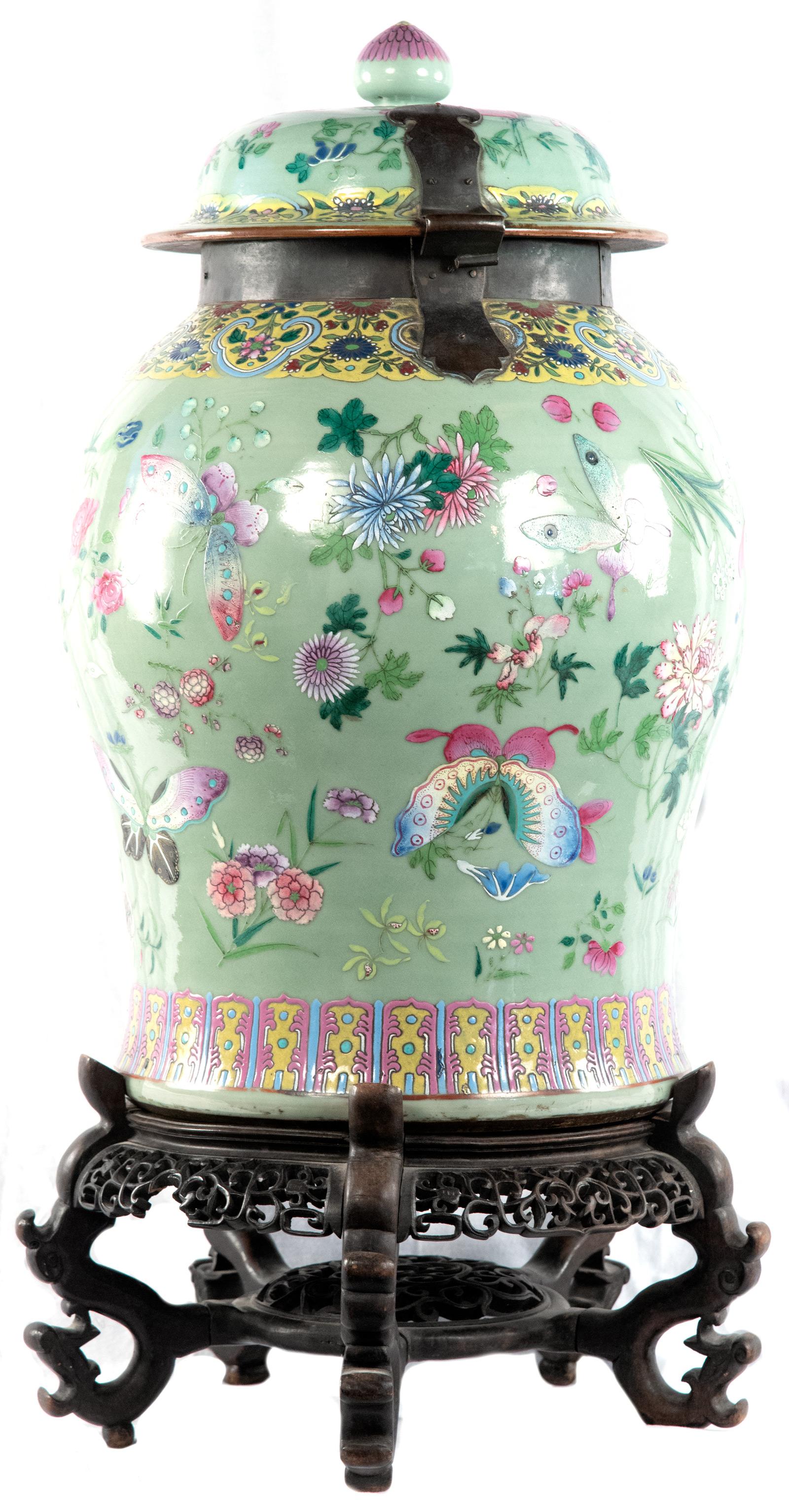 A Qing-dynasty famille verte Chinese porcelain baluster vase with cover with 19th century bronze collar and fixtures on a carved rosewood stand.