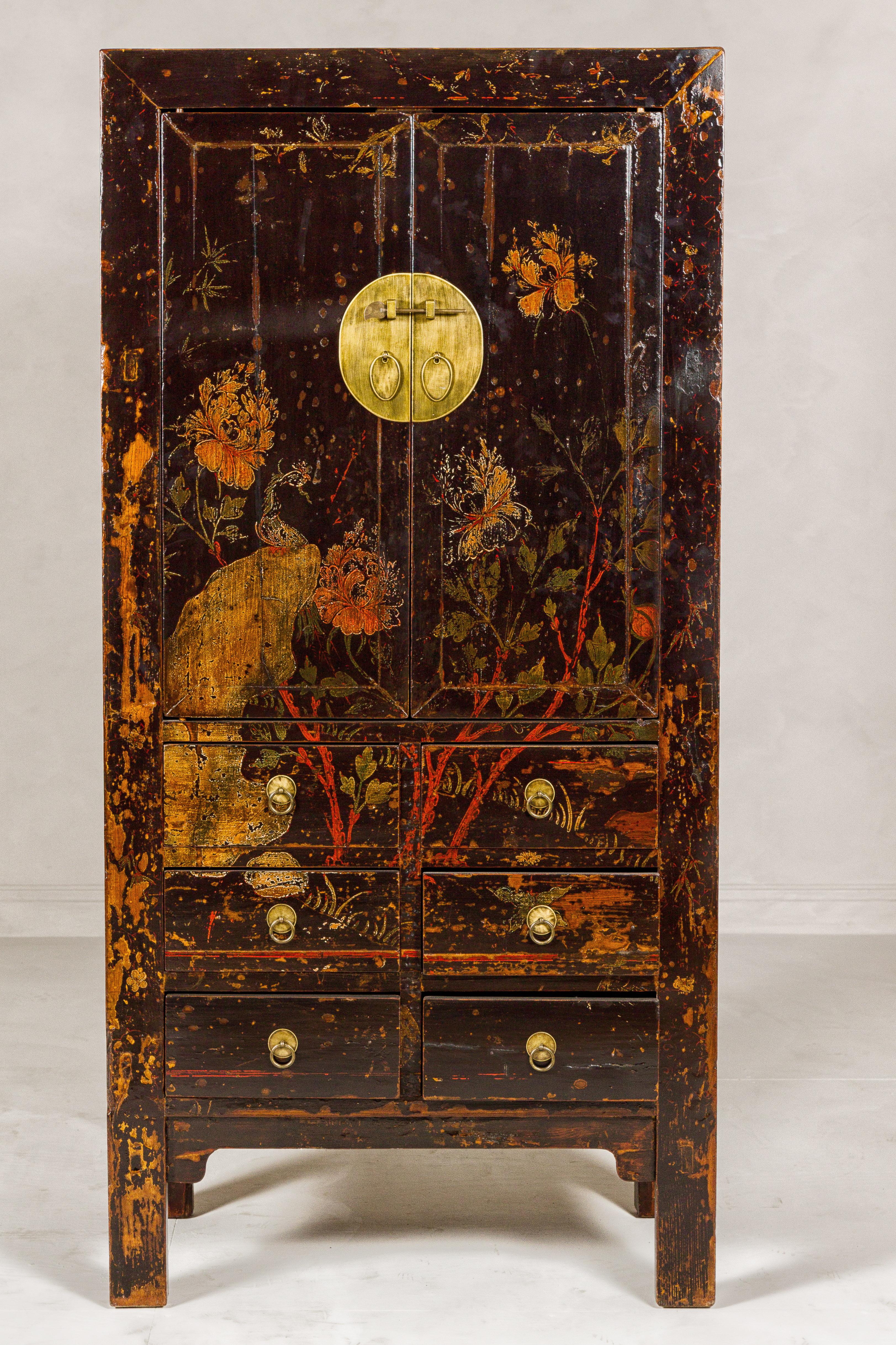 A Qing Dynasty period hand-painted cabinet from the 19th century with hand-painted floral décor, two doors and six drawers. This Qing Dynasty period cabinet from the 19th century is a captivating blend of historical elegance and artistic charm. The
