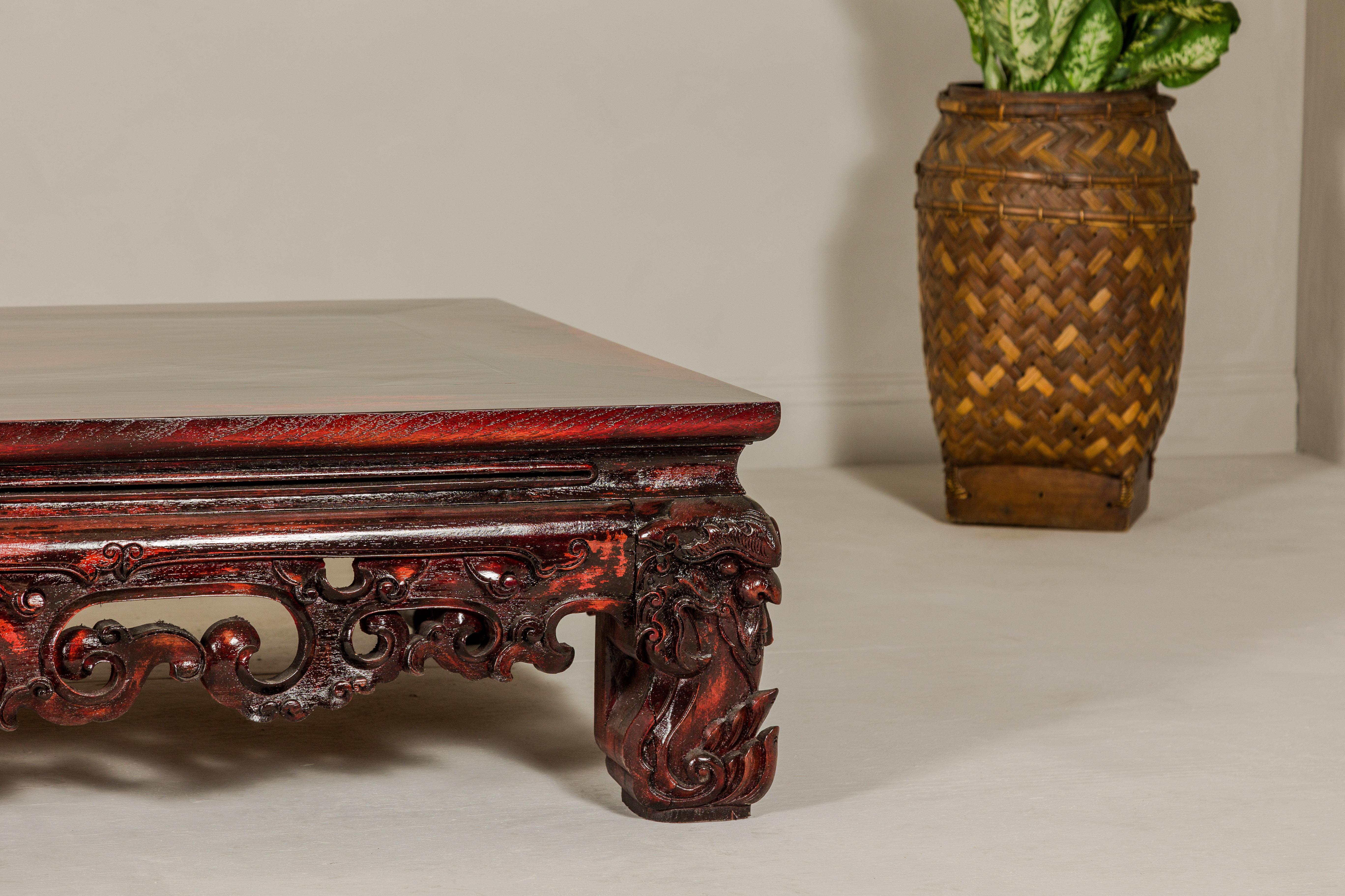Wood Qing Dynasty Low Kang Coffee Table with Reddish Brown Finish and Carved Décor For Sale