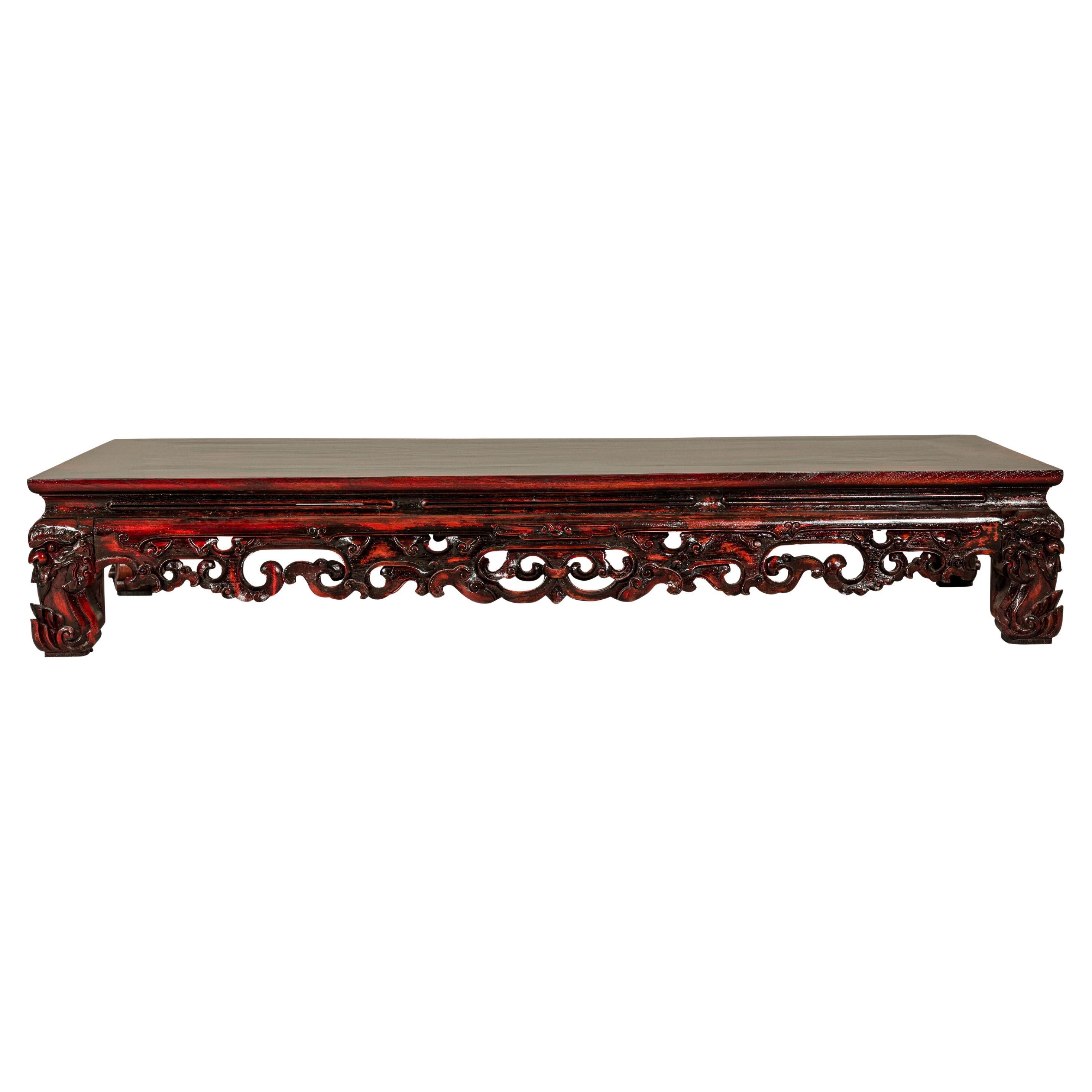 Qing Dynasty Low Kang Coffee Table with Reddish Brown Finish and Carved Décor For Sale
