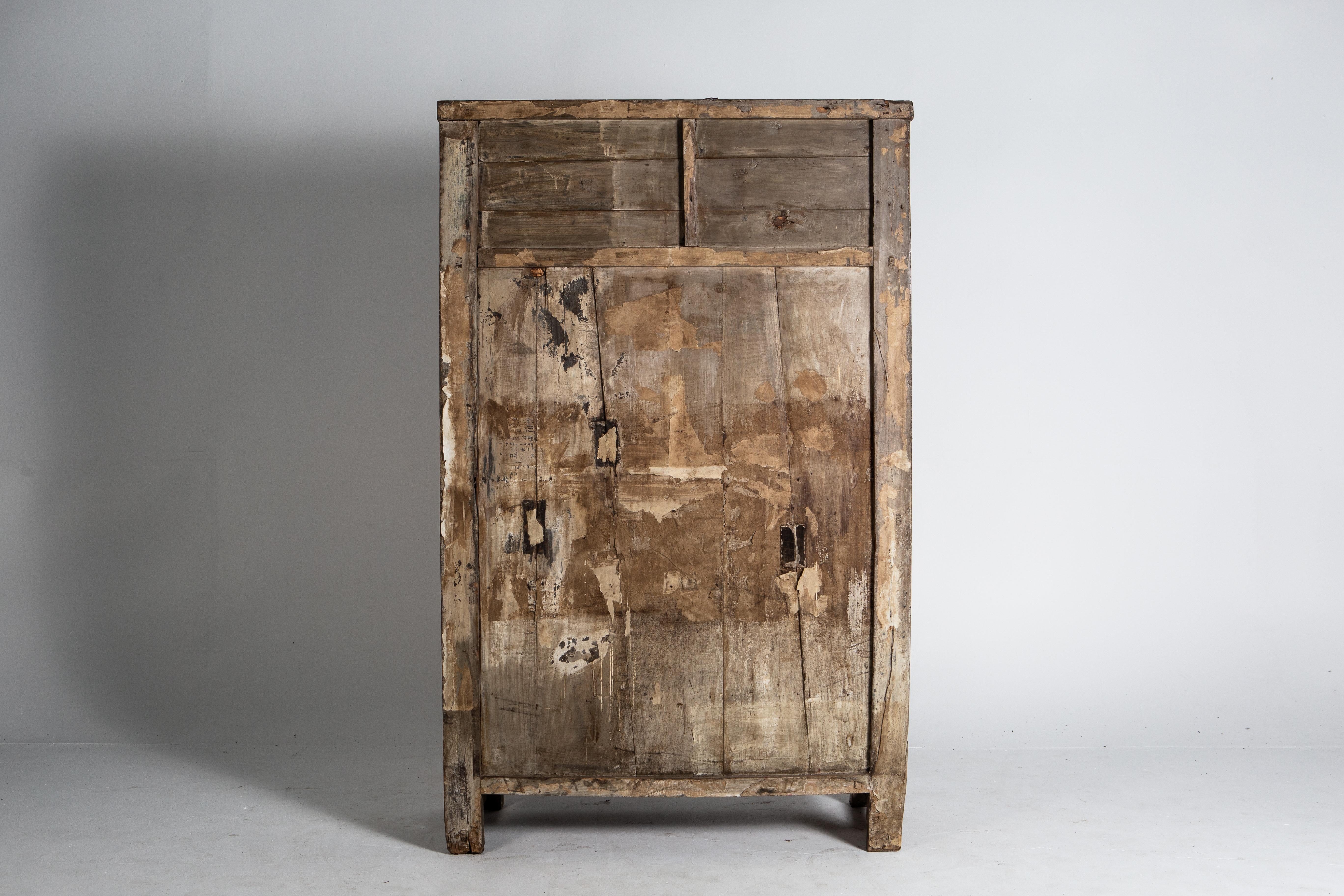 This apothecary cabinet has a beautiful aged patina. The piece has 35 drawers with traces of elegant calligraphy, indicating the contents of each. The addition of an open display shelf above now provides room for books, vases, or other decorative