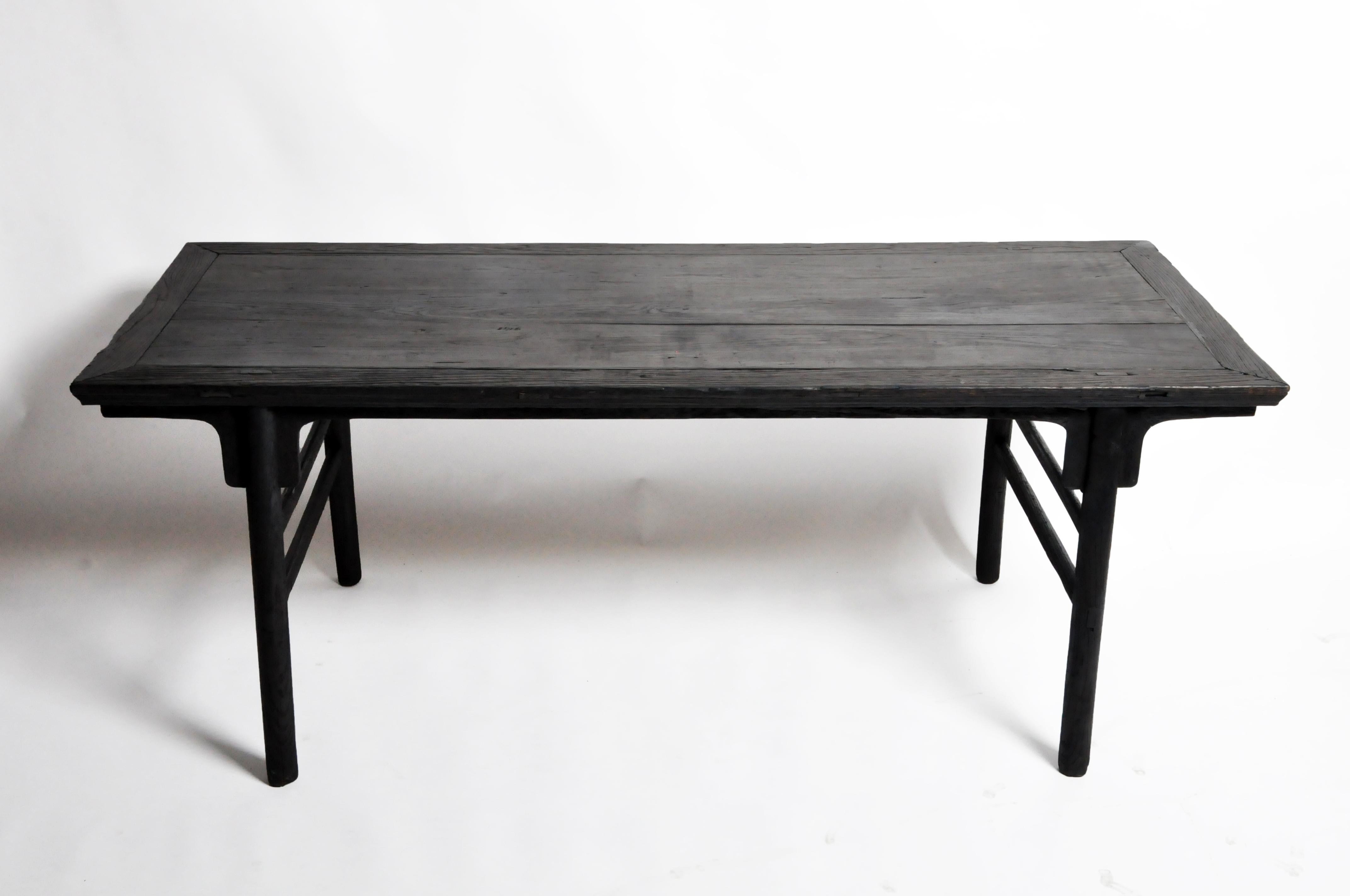 This table is simple in its design. The legs are set back from the edge of the tabletop and are slightly splayed to provide stability. The apron is straight and unadorned. A pair of rounded stretchers provide additional support. Like most Chinese