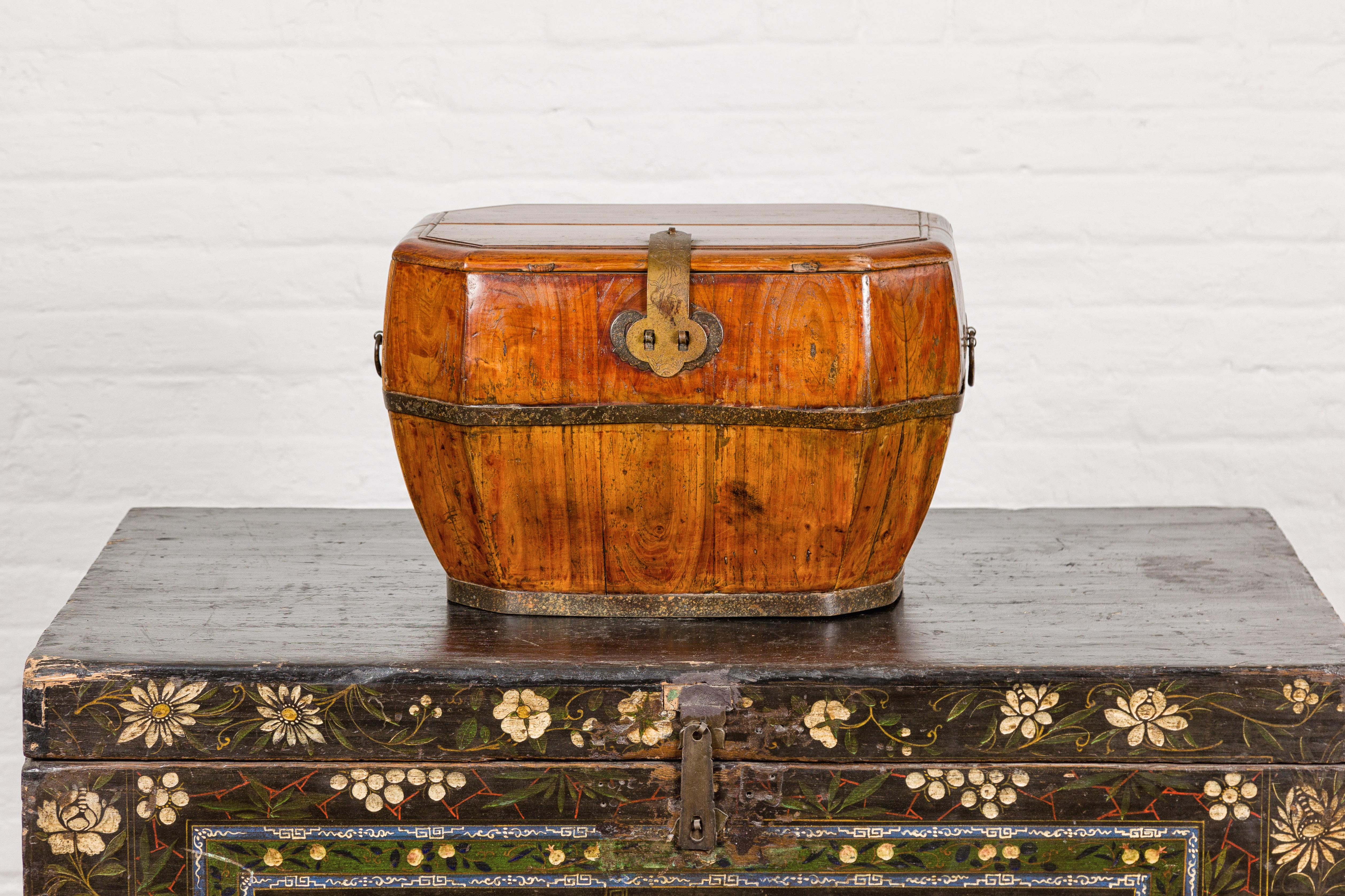 A Qing Dynasty period Chinese old box from the 19th century with traditional etched brass hardware, metal banding, partially removable top and light patina. Immerse yourself in the rich history of the Qing Dynasty with this exquisite 19th-century