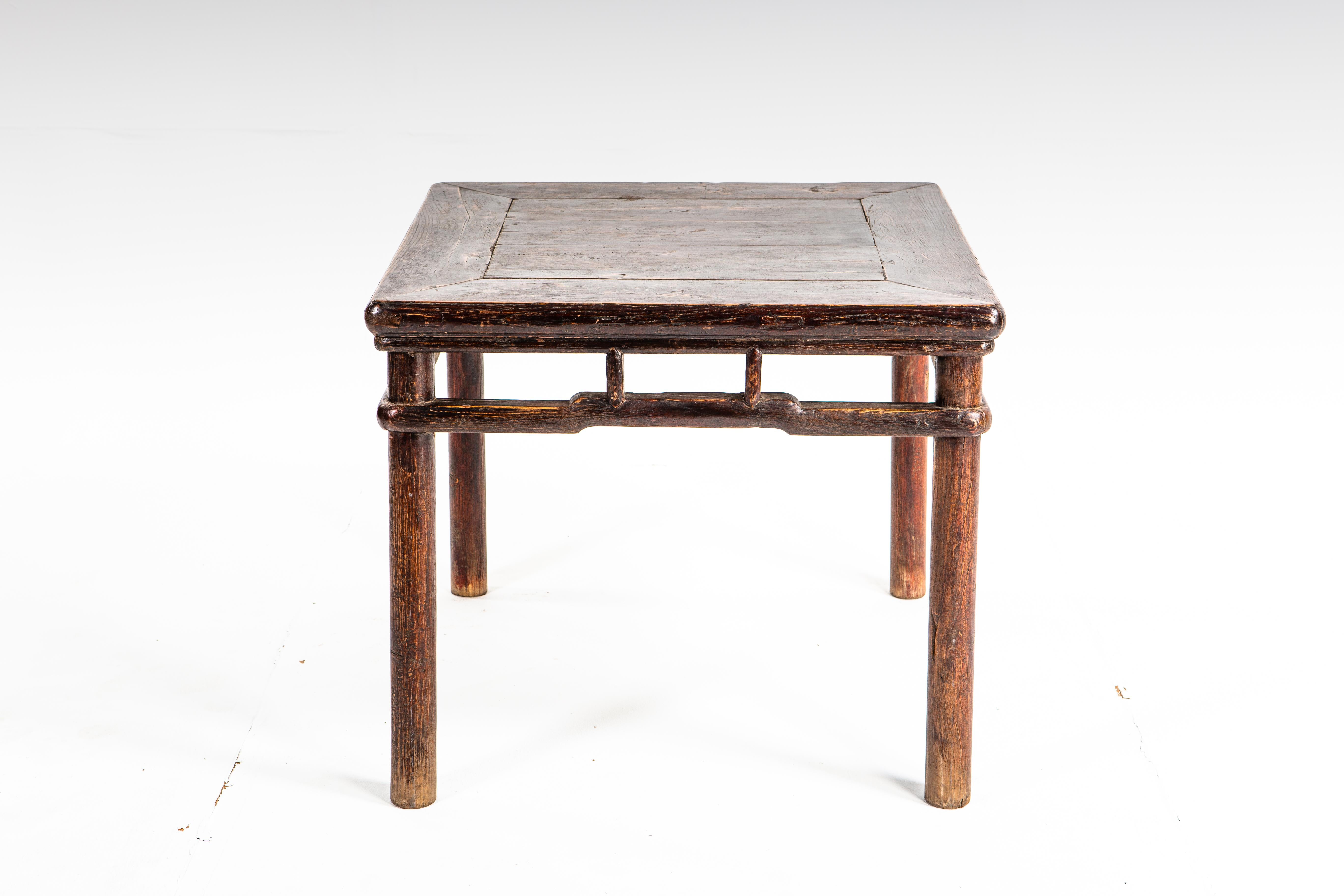This small side table dates to the middle-Qing dynasty. The piece is made of elm wood and features humpback stretchers and a beautifully aged patina.