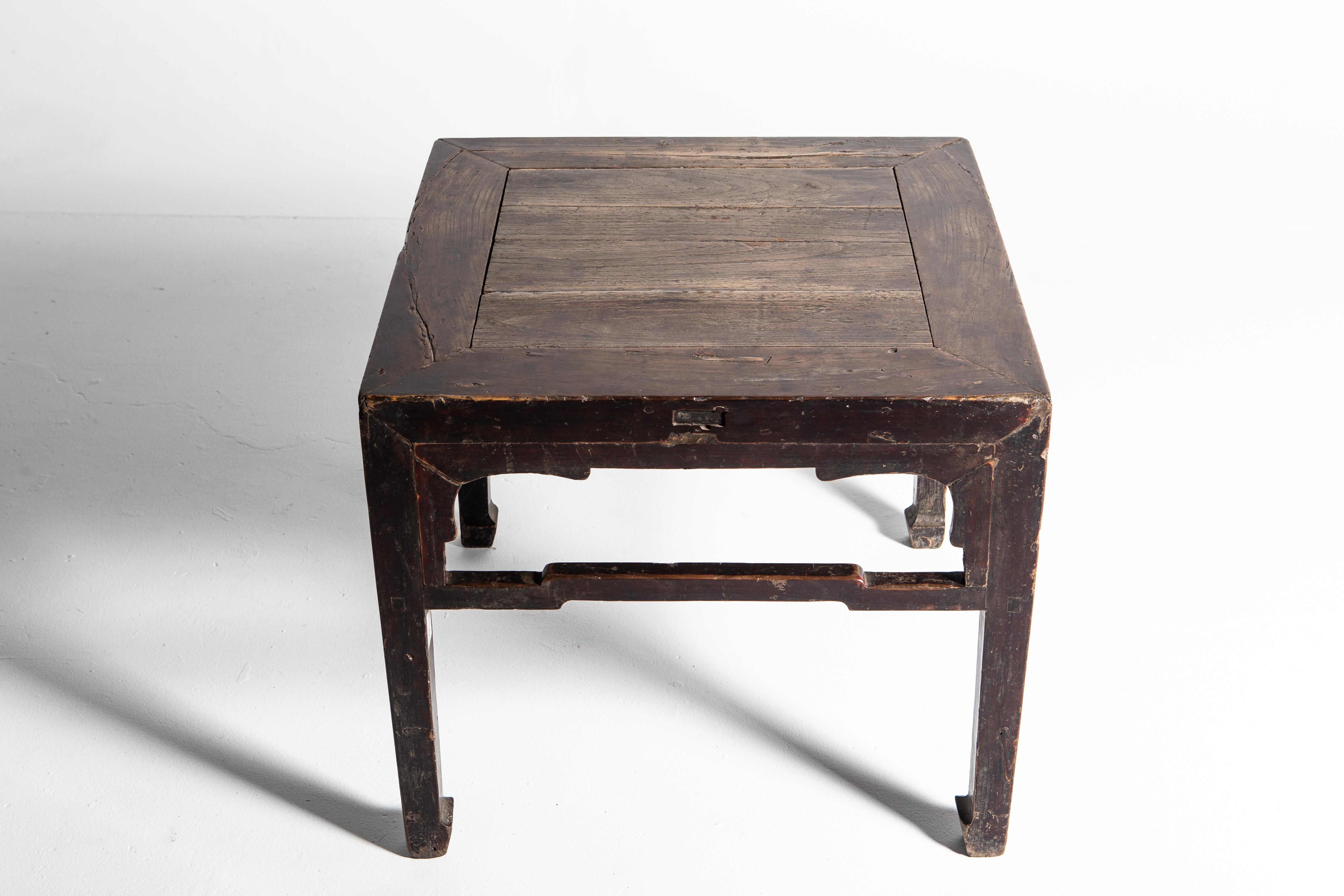 This small side table dates to the middle-Qing dynasty. The piece is made of elmwood and features humpback stretchers and a beautifully aged patina.