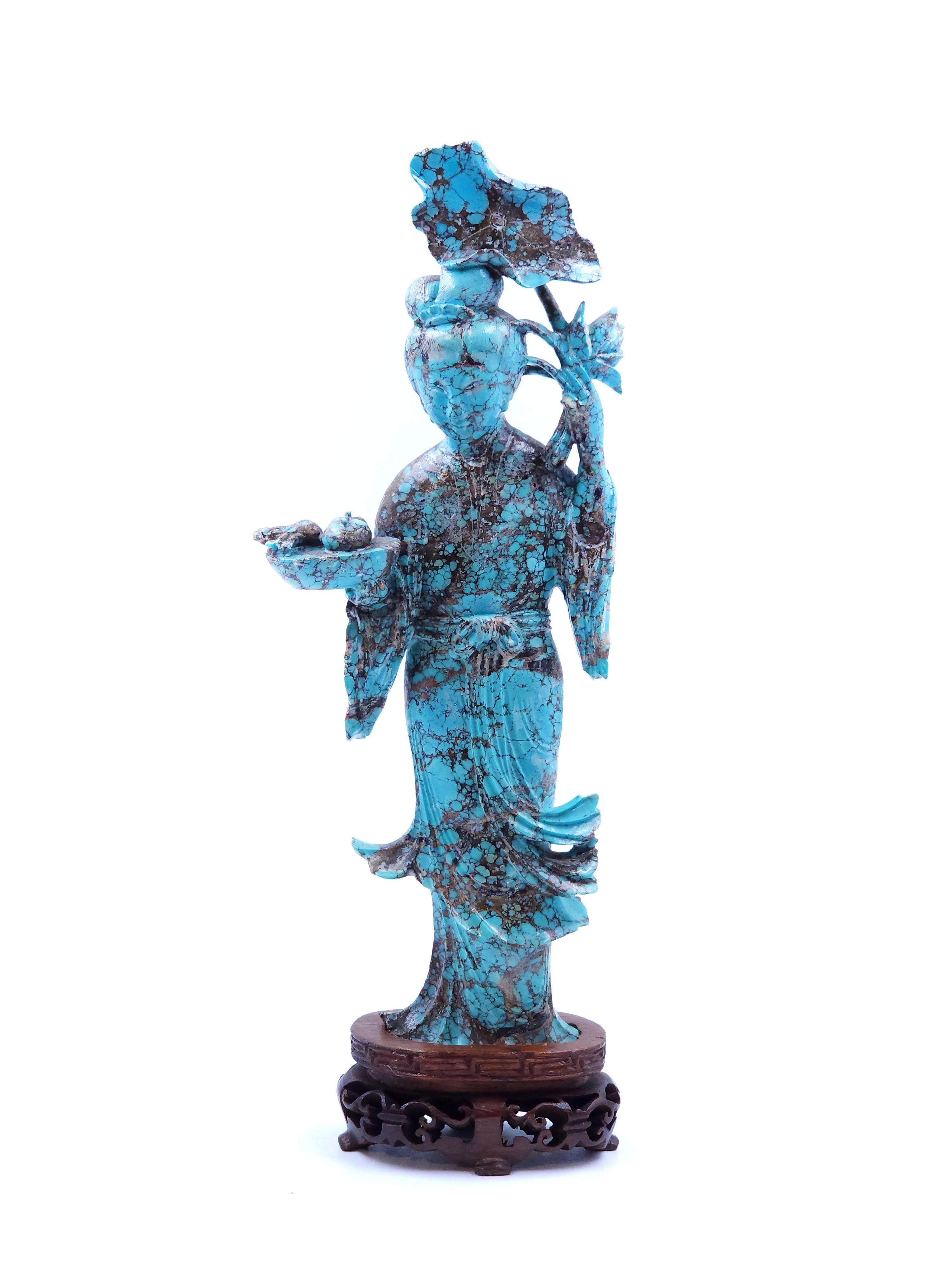 Qing Dynasty oriental lady standing in carved turquoise
Elegant figure of a woman carved in turquoise stone, with traditional Chinese clothes and in one hand she holds a basket of fruits and with the other flowers. The base also consists of a design