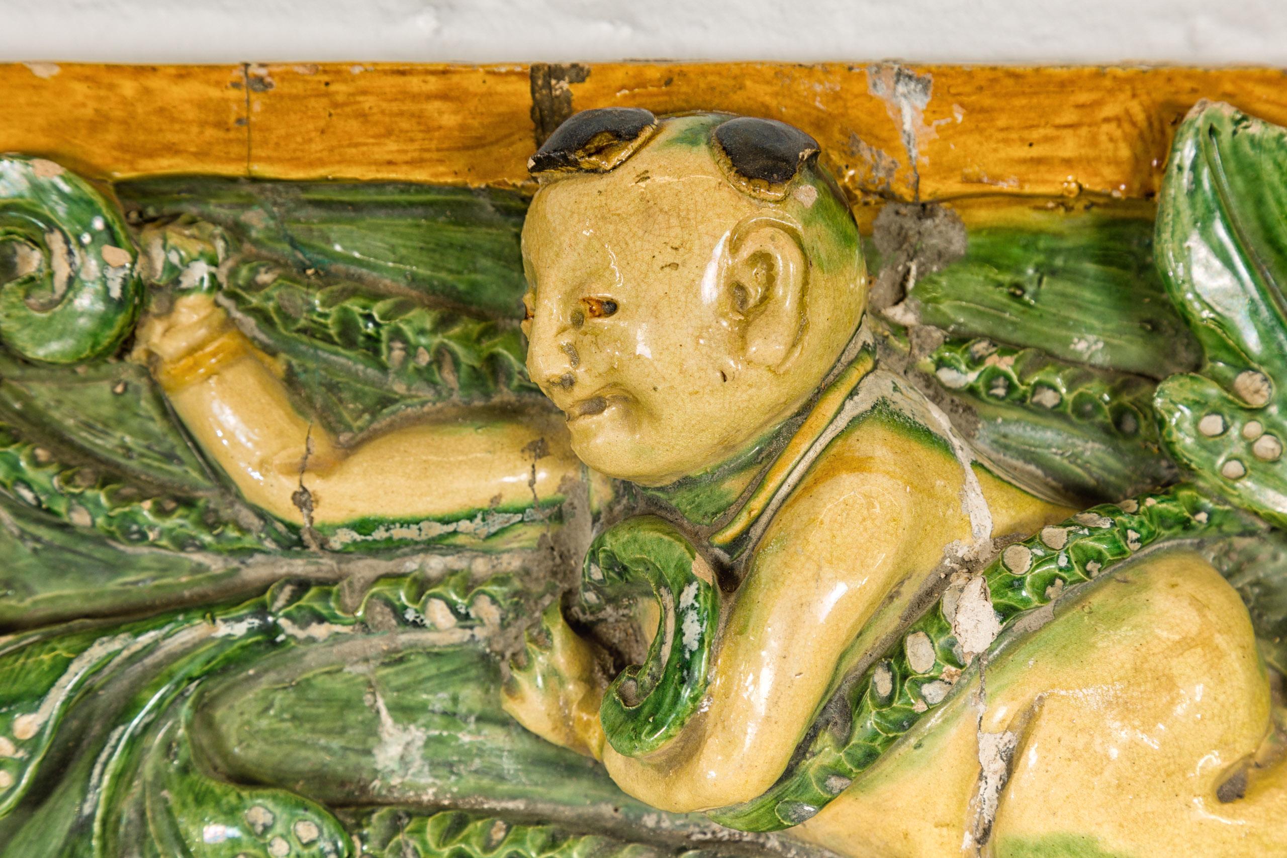 Qing Dynasty Tricolor Roof Fragment from a Temple Depicting a Boy Amidst Leaves For Sale 3
