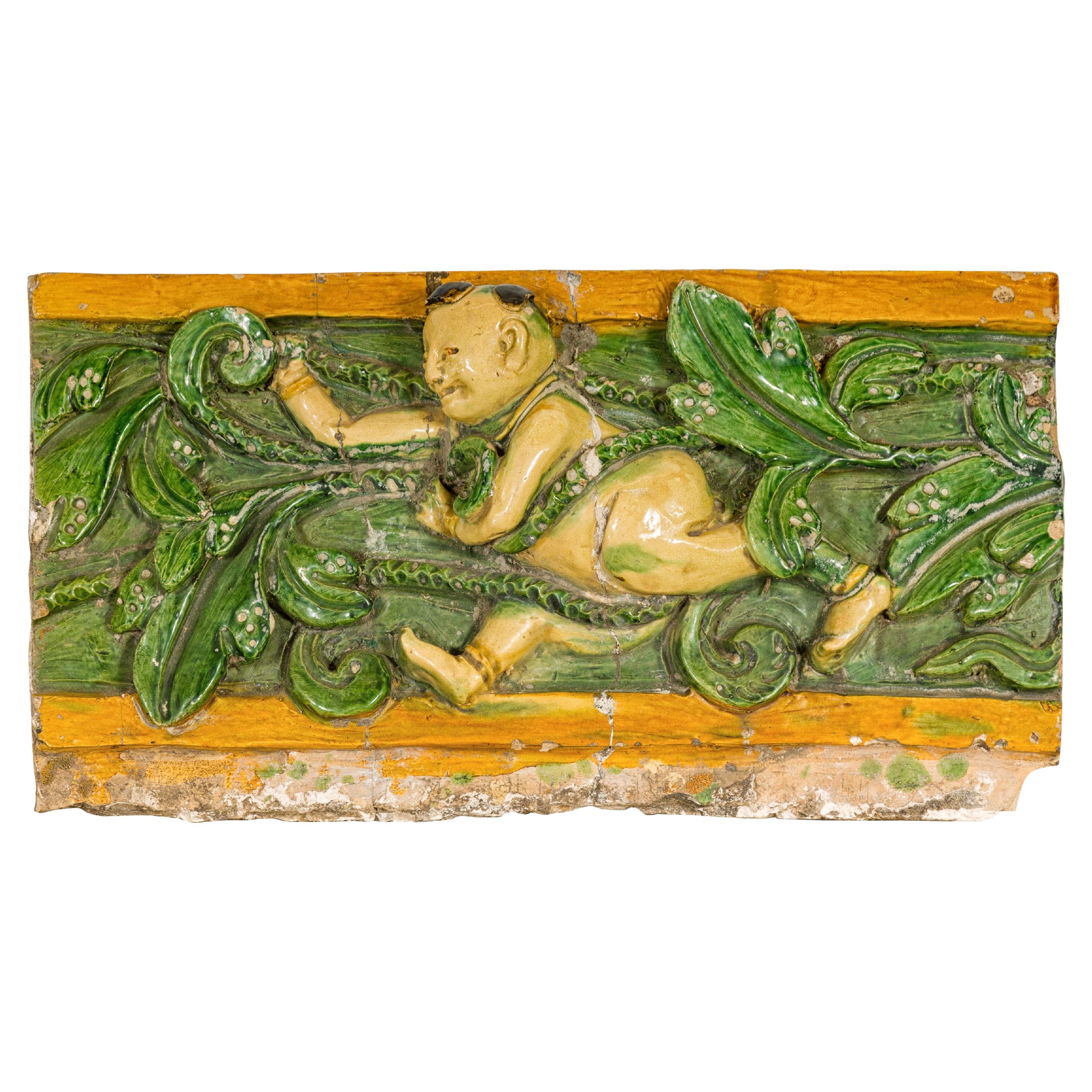 Qing Dynasty Tricolor Roof Fragment from a Temple Depicting a Boy Amidst Leaves For Sale