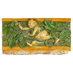 Qing Dynasty Tricolor Roof Fragment from a Temple Depicting a Boy Amidst Leaves