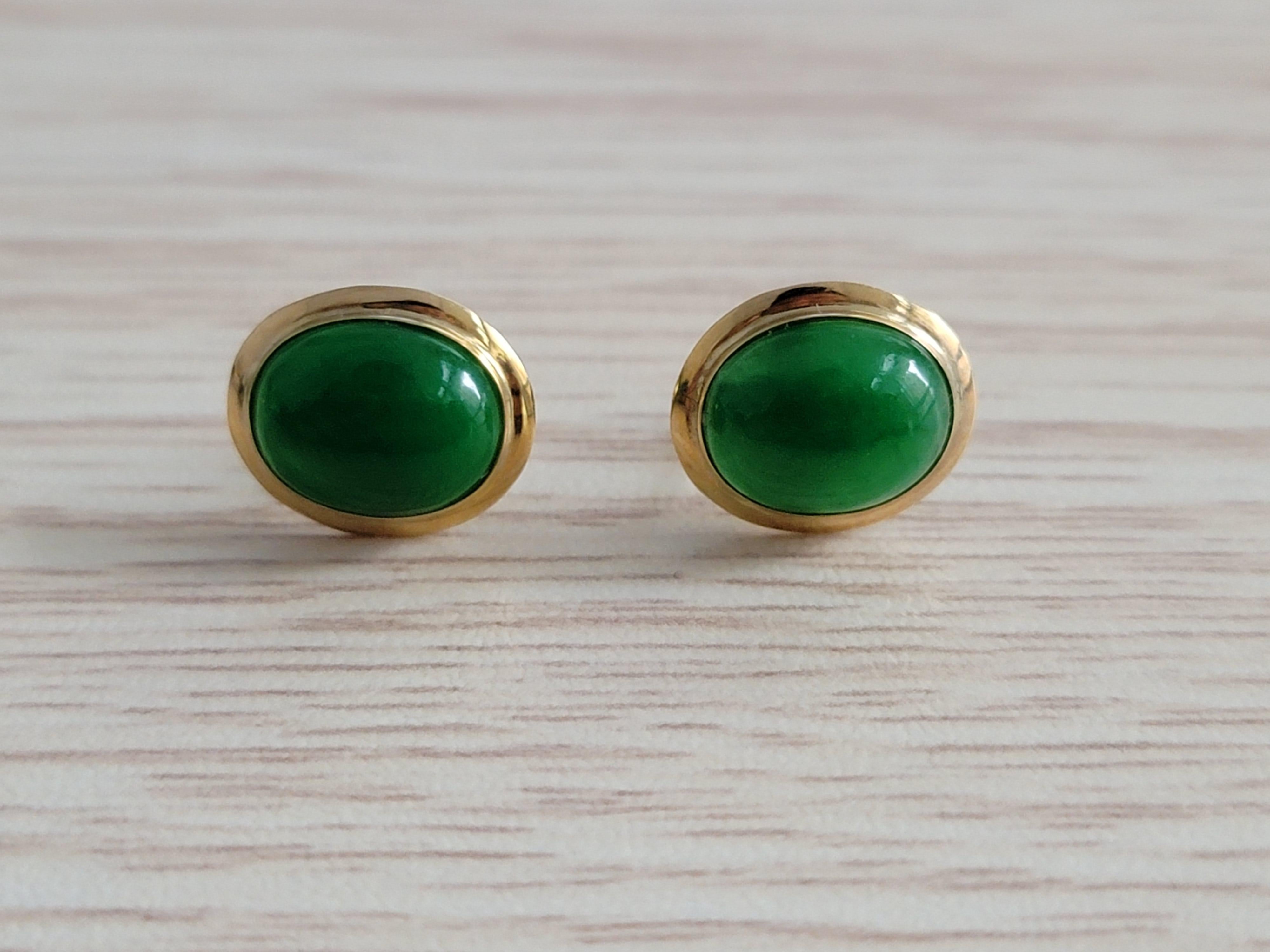 Stud Green Jadeite Earrings with solid 14K Yellow Gold. Jadeite Cabochon engulfed in 14K Yellow Gold Circumference and earring prongs with stud backs. 

The 'Qīng Zhong Jade Earrings’ represent nature’s colors in Mandarin and means clear or pure.
