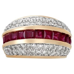 Quad-row diamond ring with channel set rubies in yellow gold