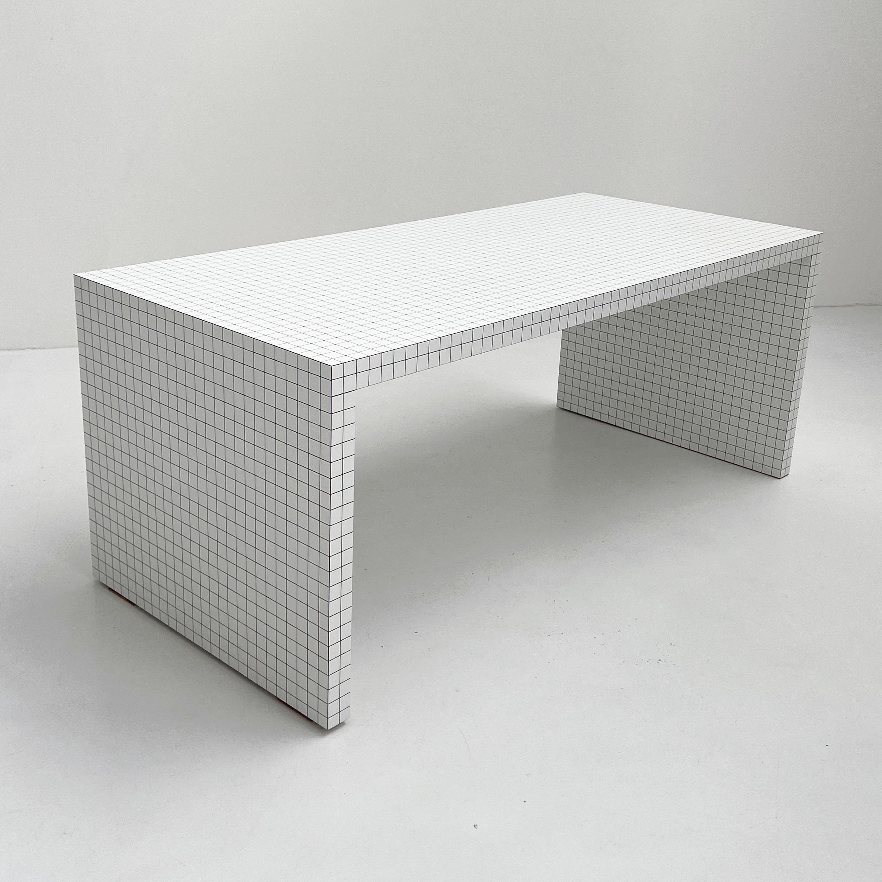 Designer - Superstudio
Producer - Zanotta
Model - Quaderna Desk
Design Period - Seventies
Measurements - Width 180 cm x Depth 80 cm x Height 75 cm
Materials - Wood
Color - Back, white
Comments - Some light scuffs/breaches on 1 edge of the table