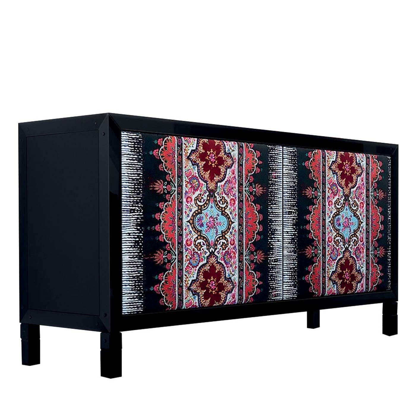 Part of the Quadra collection, this sideboard's door panels are upholstered with a splendid embroidered fabric (65% linen, 20% polyester and 15% cotton), that enlivens the austere black-lacquered frame of Toulipier walnut wood and Tanganica veneer.
