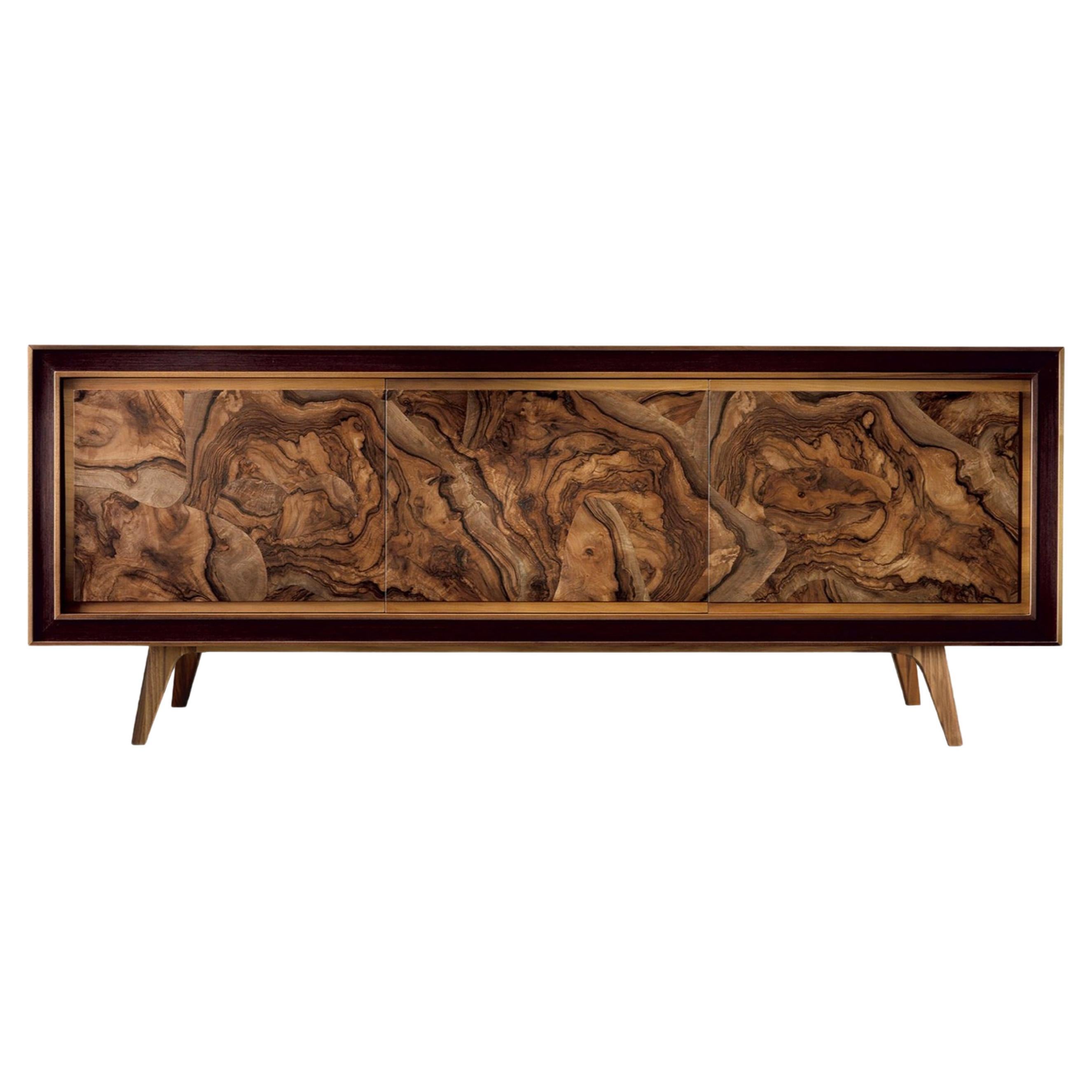 An elegant, stunning sideboard finely crafted in Italy with passion by expert hands. It's composed of three doors in premium solid walnut with fine root veneer, each piece is unique, presenting different wood veins. The oil finish brings out the