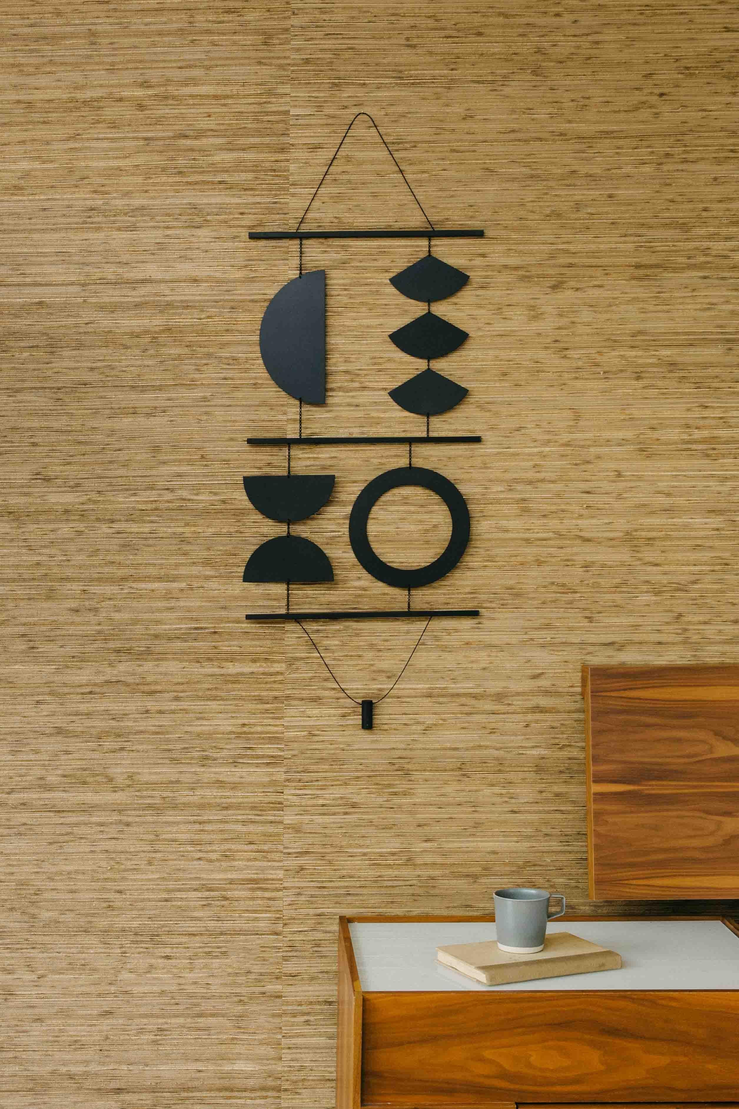 The Quadrant Wall Hanging is referential to hanging tapestries and mid-century design. The unique composition is accentuated by the larger scale and bold geometric components. The striking black finish adds a graphic feeling to this distinctive