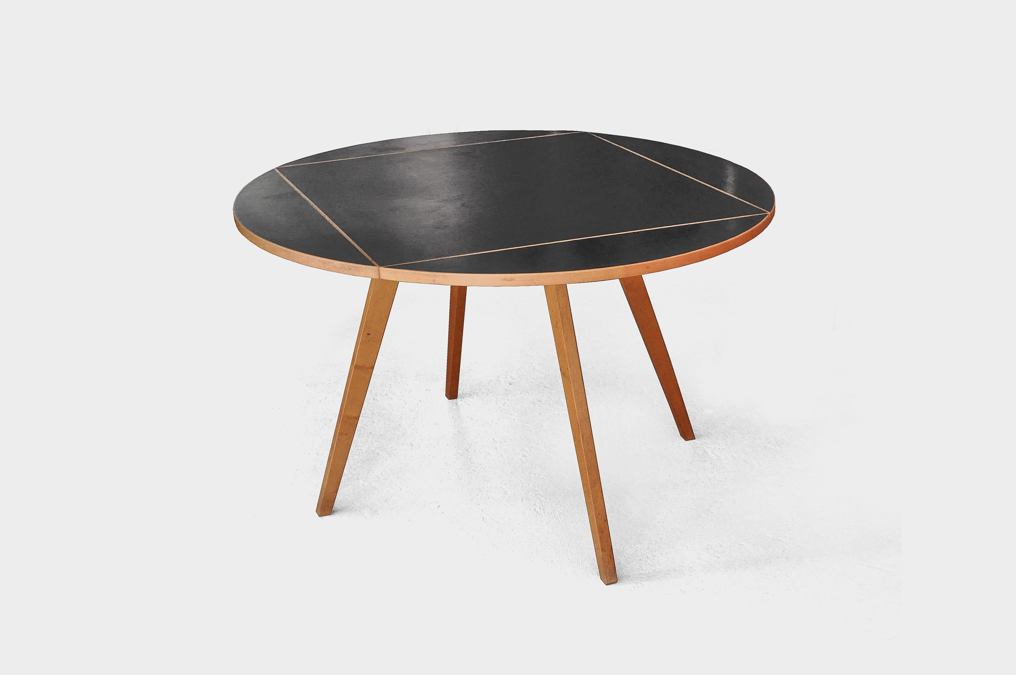 Dining table by Max Bill for Horgen Glarus. The table top can be changed from a round to a square shape by turning it. This table is one of Max Bill's most important designs and the translation of his idea of concrete art into furniture design. It
