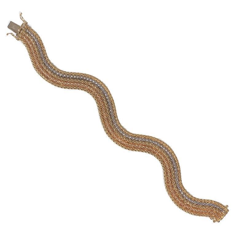 BERNARDO ANTICHITÀ PONTE VECCHIO FLORENCE
Designed as an articulated three-coloured gold undulating band.

Concealed clasp. Signed Quadri on the back.
Mounted in 18Kt yellow rose and white gold

19.5 cm long

Weight: 32 gr 
