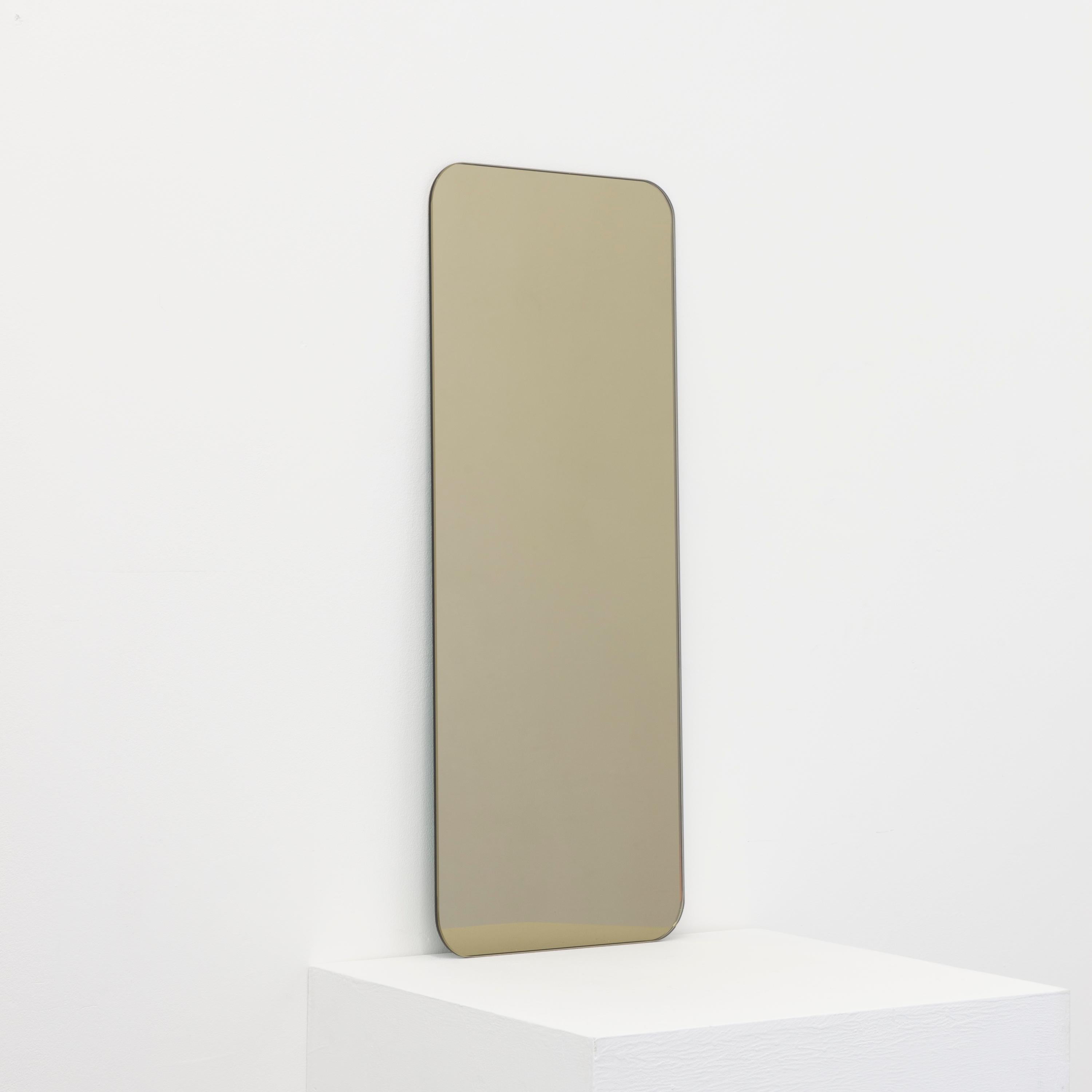 Minimalist rectangular shaped frameless bronze tinted mirror with a floating effect. Quality design that ensures the mirror sits perfectly parallel to the wall. Designed and made in London, UK.

Fitted with professional plates not visible once
