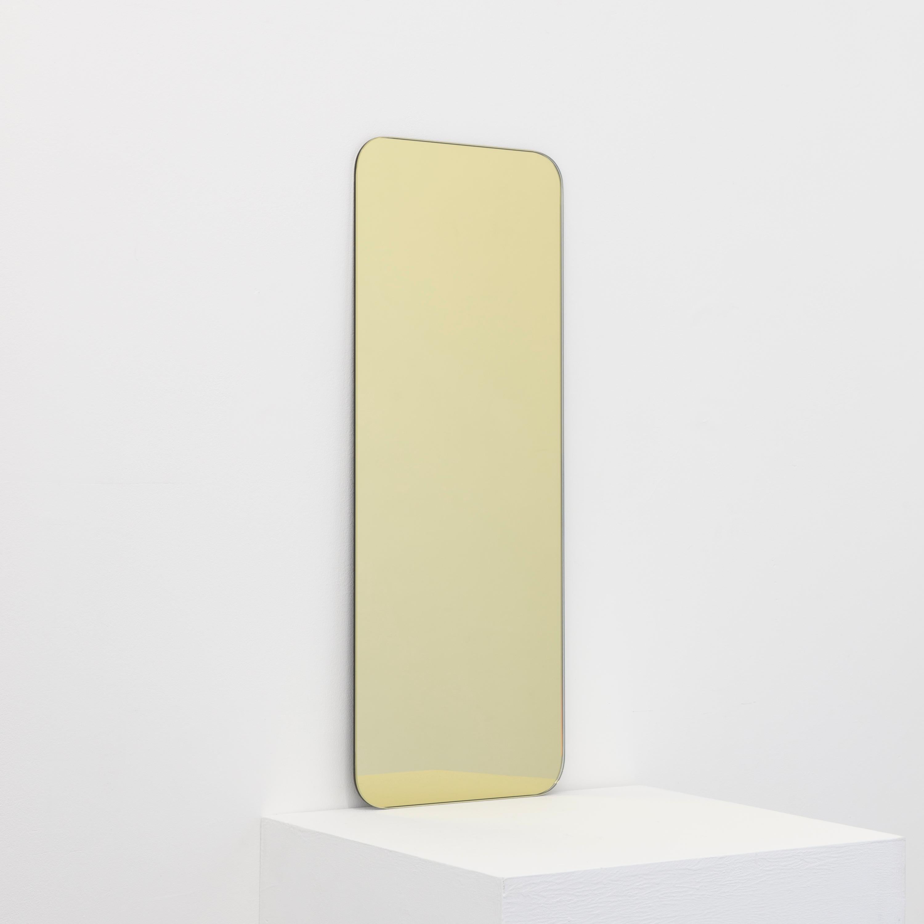 Minimalist rectangular shaped frameless gold tinted mirror with a floating effect. Quality design that ensures the mirror sits perfectly parallel to the wall. Designed and made in London, UK.

Fitted with professional plates not visible once