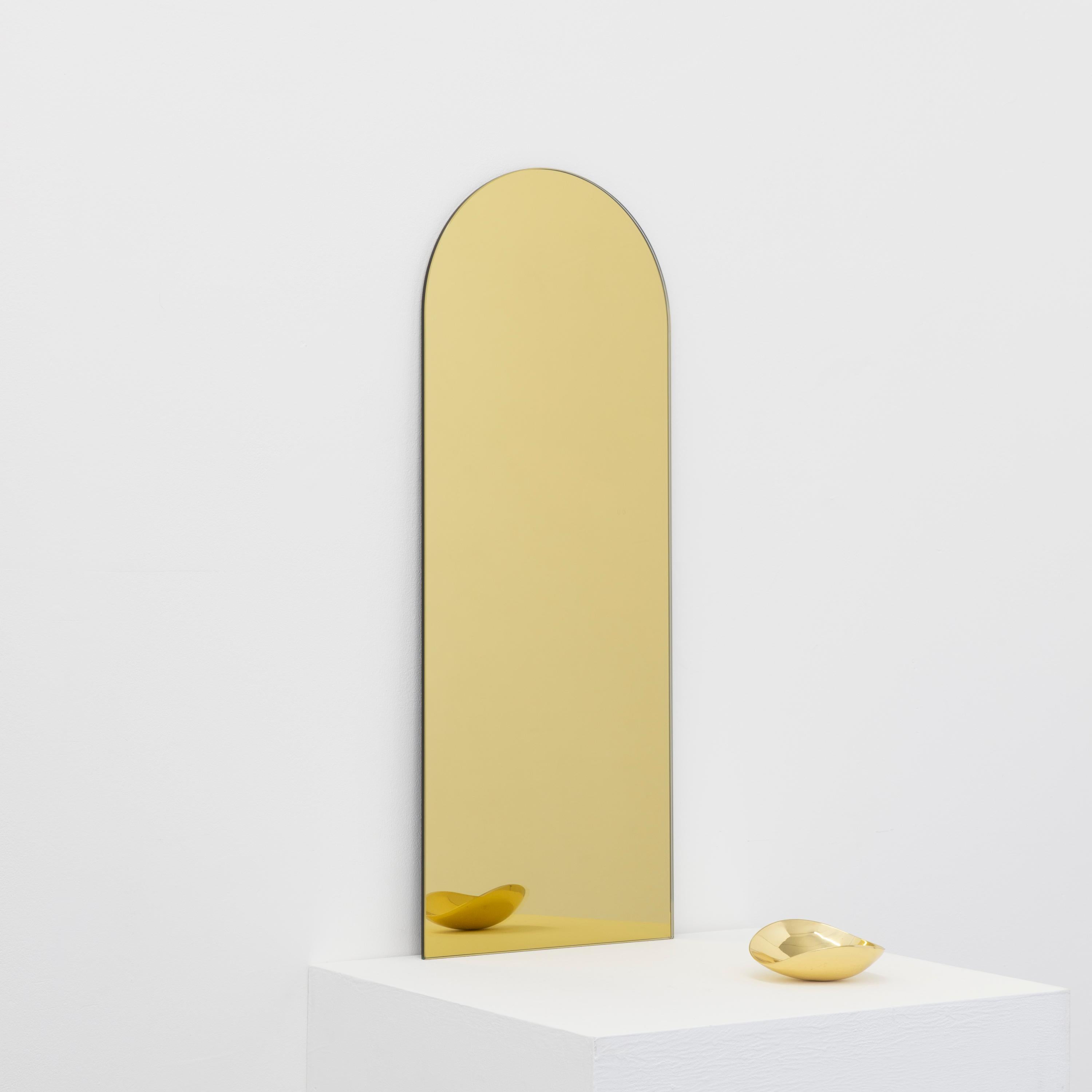 Minimalist rectangular shaped frameless gold mirror with a floating effect. Quality design that ensures the mirror sits perfectly parallel to the wall. Designed and made in London, UK.

Fitted with professional plates not visible once installed for