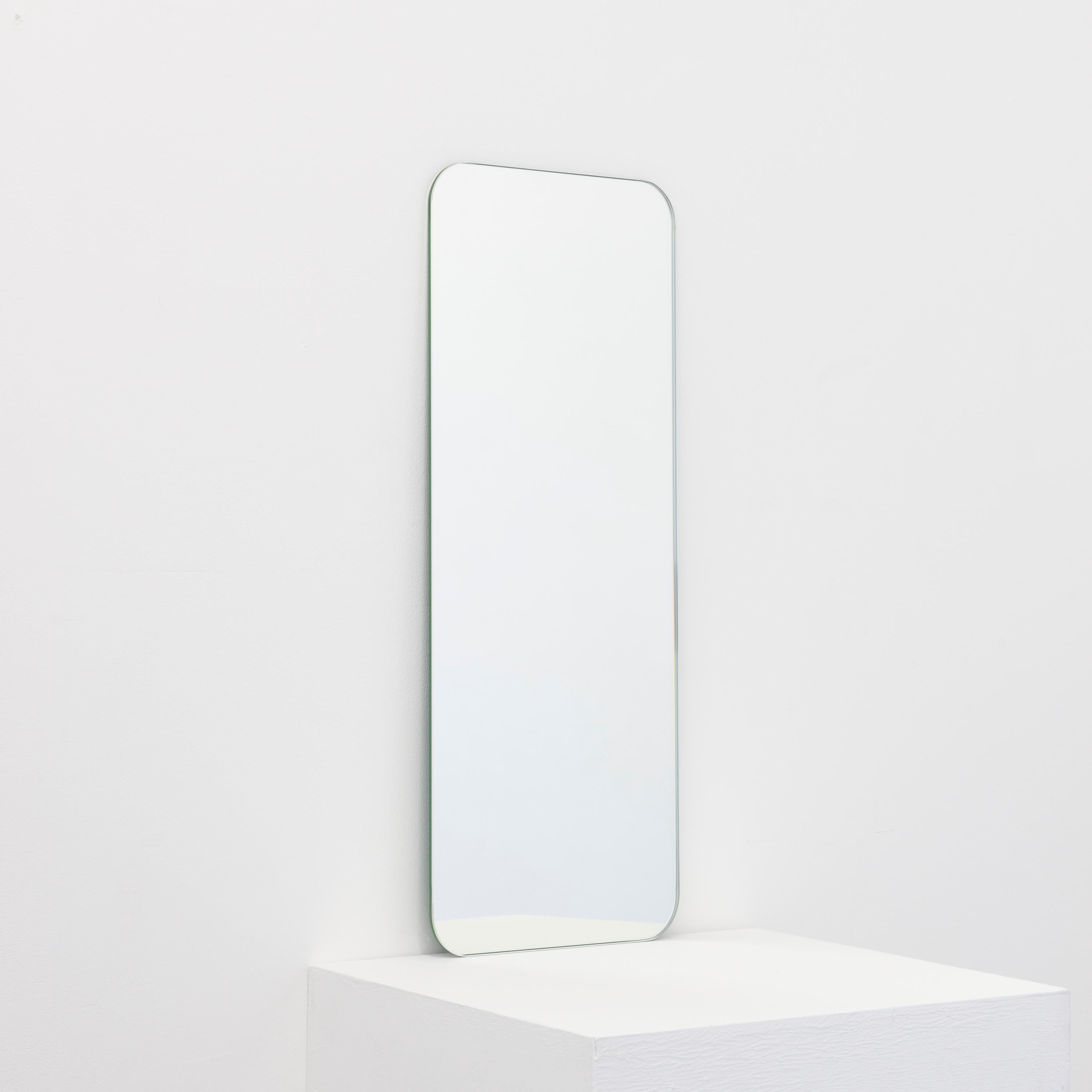 Minimalist rectangular shaped frameless mirror with a floating effect. Quality design that ensures the mirror sits perfectly parallel to the wall. Designed and made in London, UK.

Fitted with professional plates not visible once installed for an