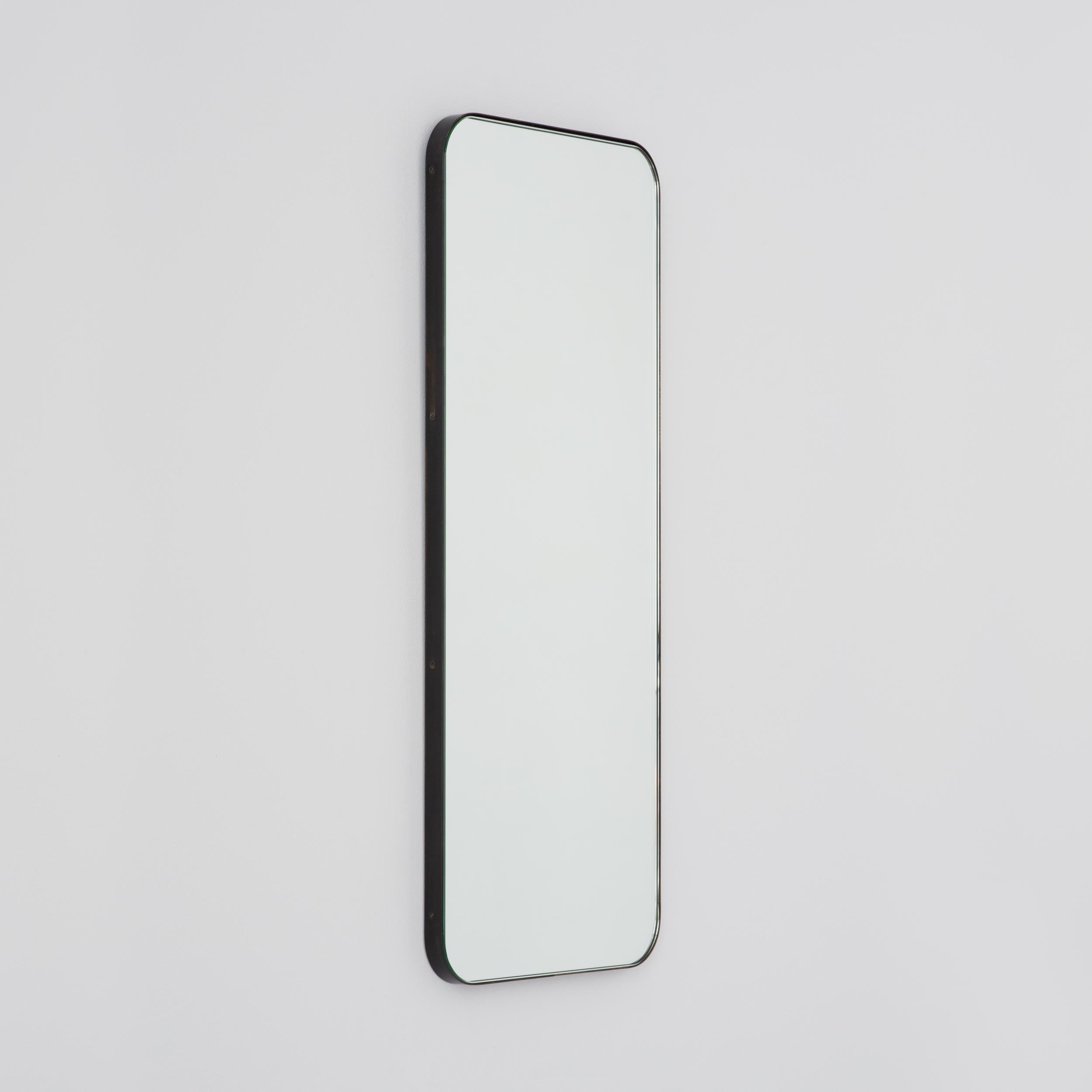 Modern rectangular mirror with an elegant bronze patina brass frame. Part of the charming Quadris™ collection, designed and handcrafted in London, UK. 

Our mirrors are designed with an integrated French cleat (split batten) system that ensures the